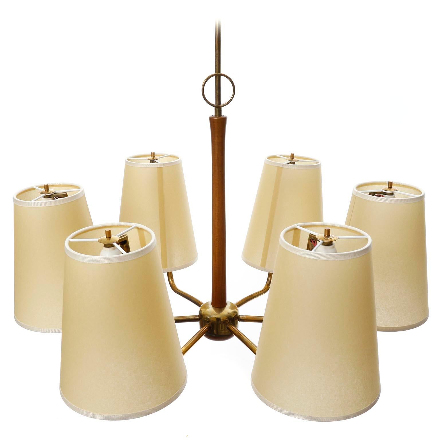 A fantastic chandelier model 'KIRI' no. 3686/6 with six arms made of brass and walnut wood with parchment lamp shades by J.T. Kalmar, Vienna, Austria, manufactured in midcentury, ca. 1960 (late 1950s or early 1960s).
The light is based on a design