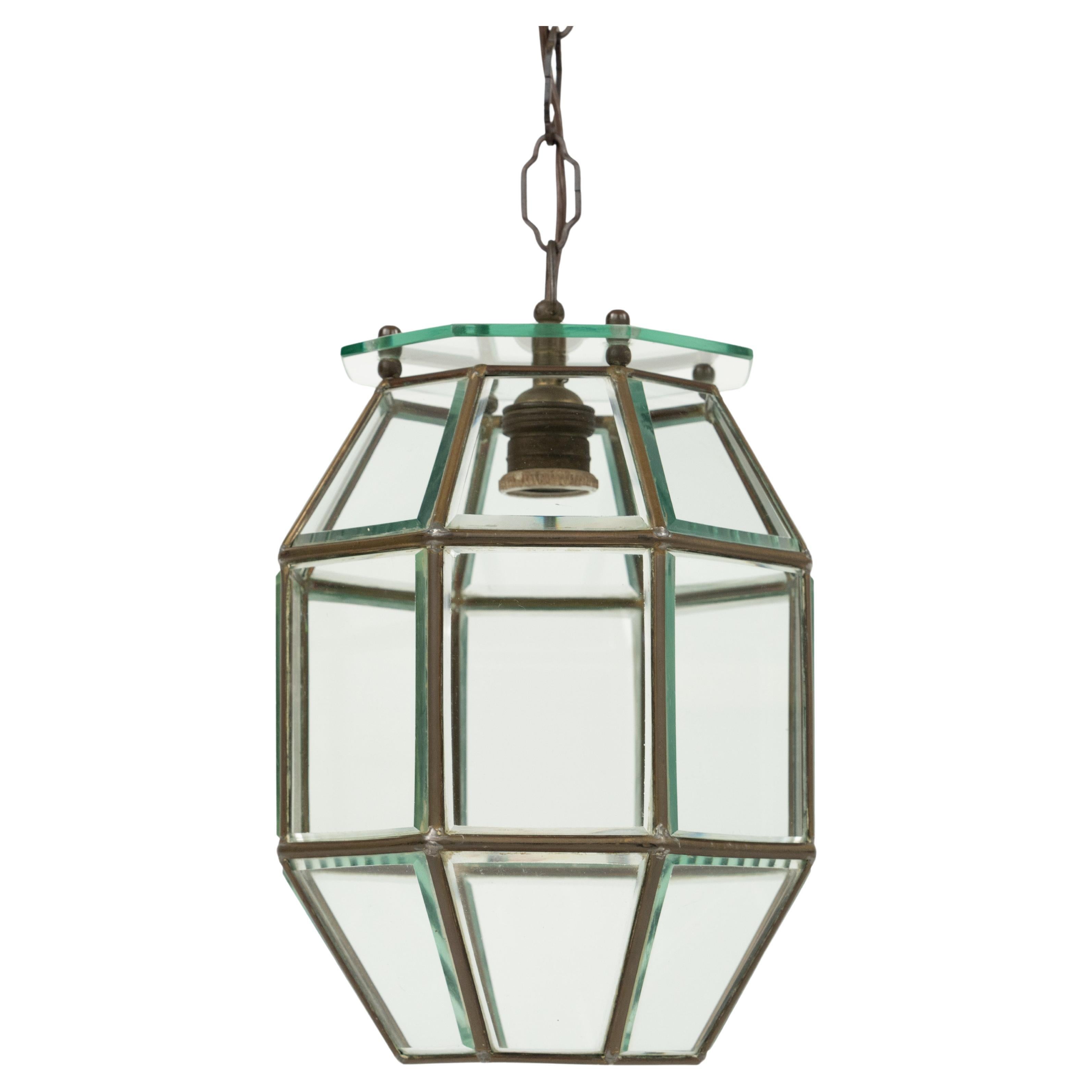 Midcentury amazing octagonal chandelier lantern in brass and beveled glass in the style of Adolf Loos.  

Made in Italy in the 1950s.  

The stunning and clear cut pendant shows twenty-four facetted clear glasses in a brass frame.   

Measures: 