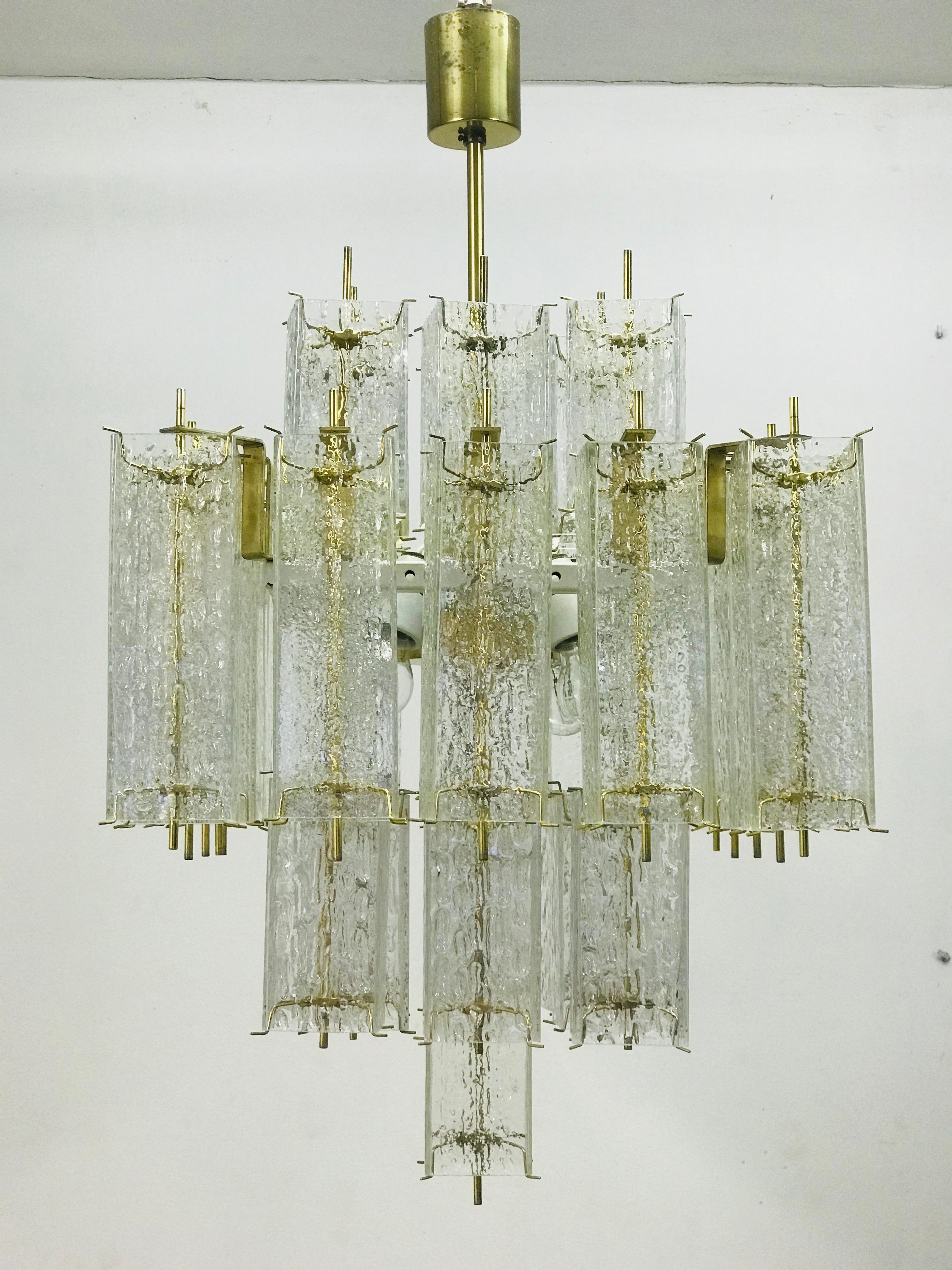 Chandelier is consisted of glass cubes (4 pieces of spare glass) and metal construction with brass fasteners. The chandelier makes a timeless body of modern times.