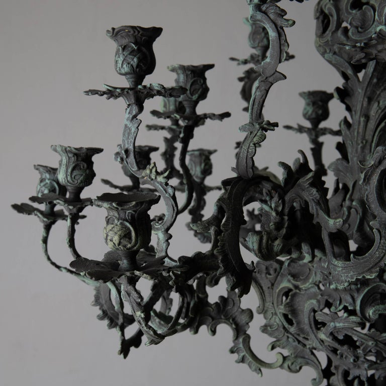 A chandelier made during the New Rococo era during the late 19th century. Refinished to look like oxidised copper. Metall is brass. Not wired. 

 