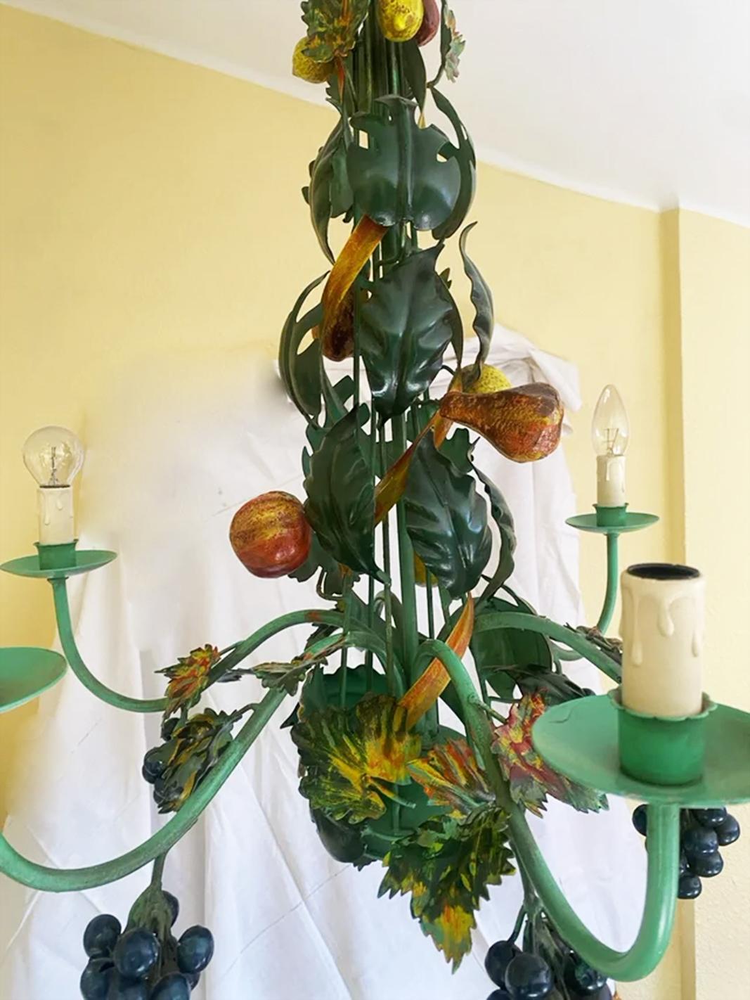 Italian iron  chandelier with leaves and fruits, Tuscan style
It is a lamp consisting of green tones
  It is a lamp made with the care that was put into the pieces previously, it is not a reproduction of those that were imported later.
The