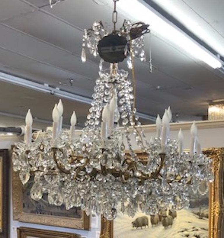 Chandelier Maria Teresa style with 
 crystal ornaments.
Beautiful chandelier illuminated by the 18 light candles, circa 1910s.

 Condition is very good. Rewired. 
Measures: 37” H x 31” W.
   