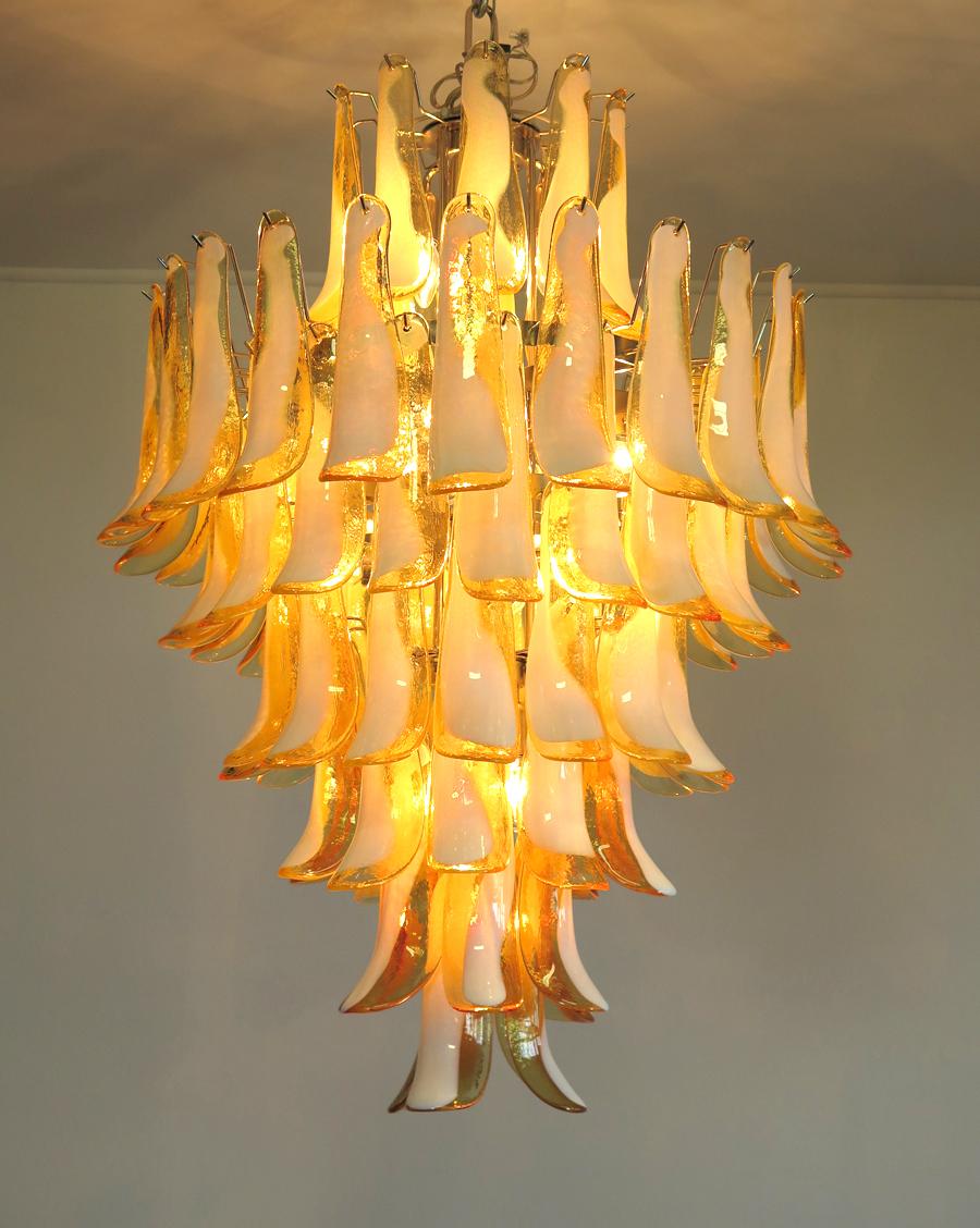 Handblown glass chandelier, composed of 85 curved,  caramel lattimo glass pieces, which are arranged on 7 tiers, suspended from a nickel metal structure.
Period: late xx century
Dimensions:  47,25 inches (120 cm) height without chain; 31,50 inches