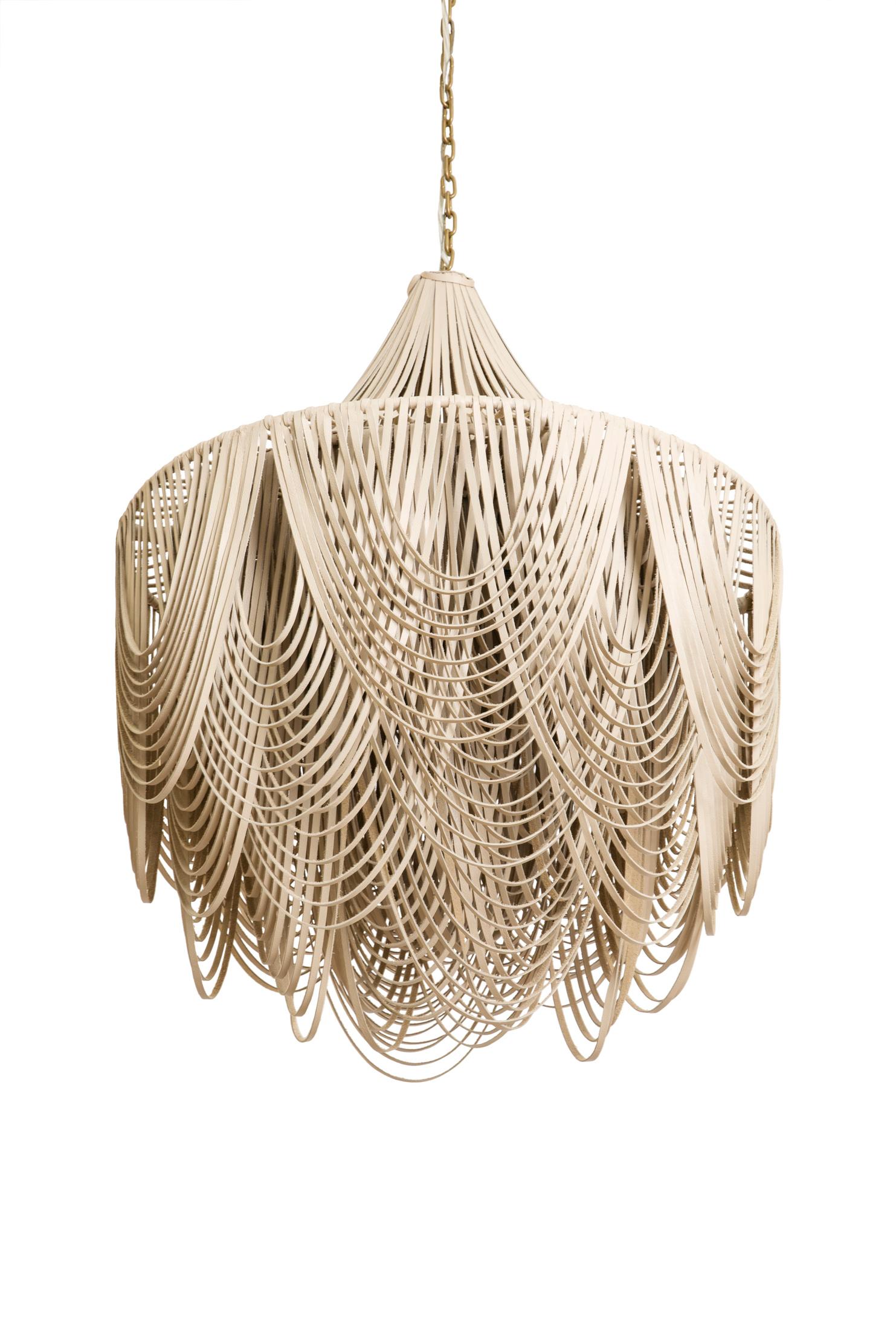 Each chandelier is hand- made with varying lengths of stripped leather, creating layers of movement and texture. The ambient light from within the fixture emerges into the room in a soft glow. All hard-wired lighting is UL-listed for dry locations.