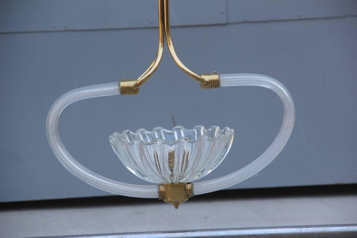Extraordinary Italian 1940s chandelier Murano art glass, made with brass and glass parts, lines and design make it the absolute protagonist with elegance out of the ordinary.
