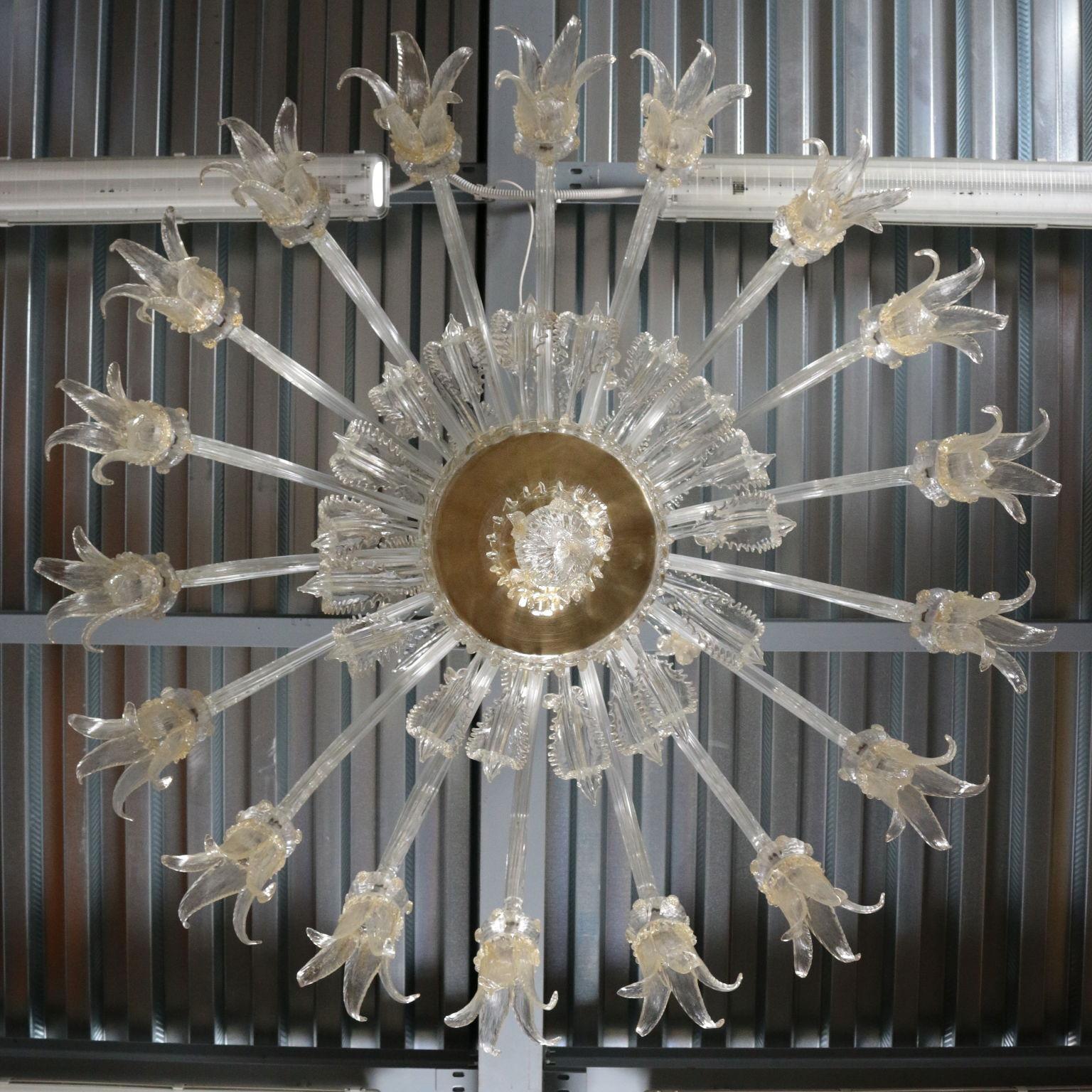 Large murano chandelier with eighteen light, in blown glass worked to recreate stems with flower corollas.