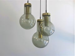 Chandelier of 3 Glass and Brass 'Maxi Globe' Pendant Lamps by RAAK, 1960's