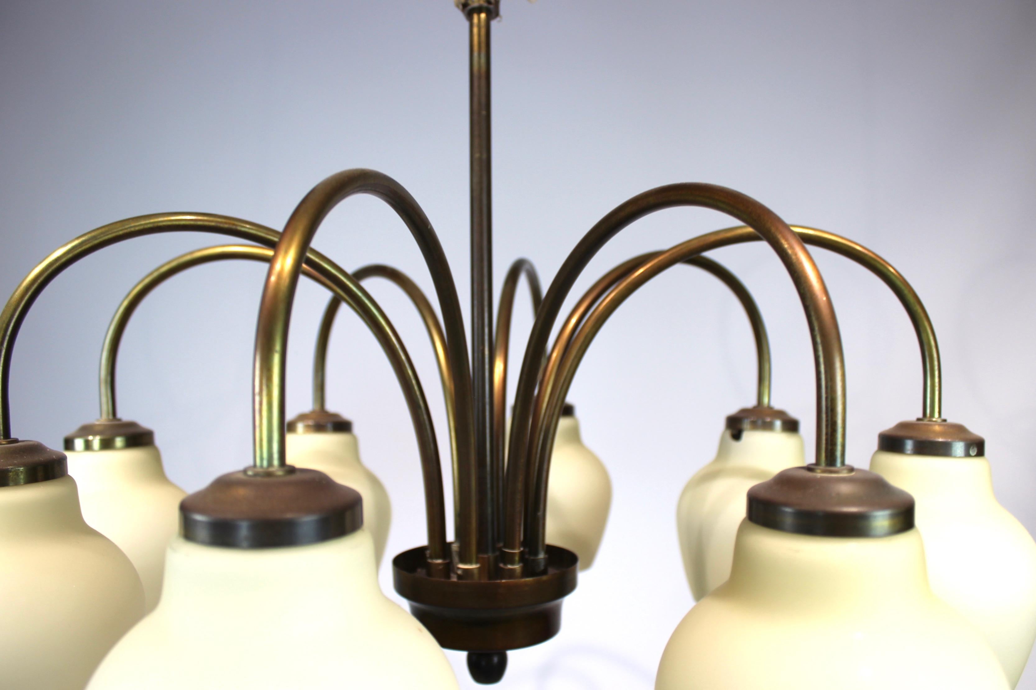 Chandelier or ceiling pendant of brass and light yellow shades by Fog & Mørup from the 1960s. The lamp is in great vintage condition.