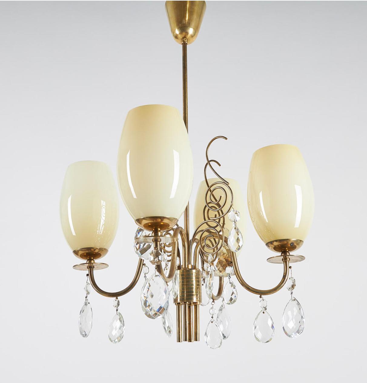 Vintage chandelier , design attributed by Paavo Tynell, produced by Idman Oy, Finland , circa 1950th. 
Brass , crystals, opaline glass shades. Stamped 