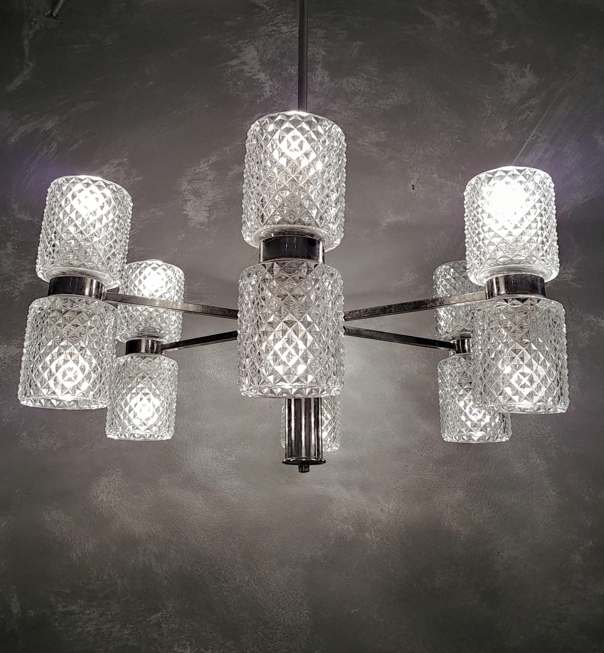 Chandelier with 12 E14 lights made in the Czech Republic in the 1960s. The chandelier was made with a chromed metal structure that supports transparent diamond-shaped Bohemia crystal glasses.



Note: We try to offer our customers an excellent