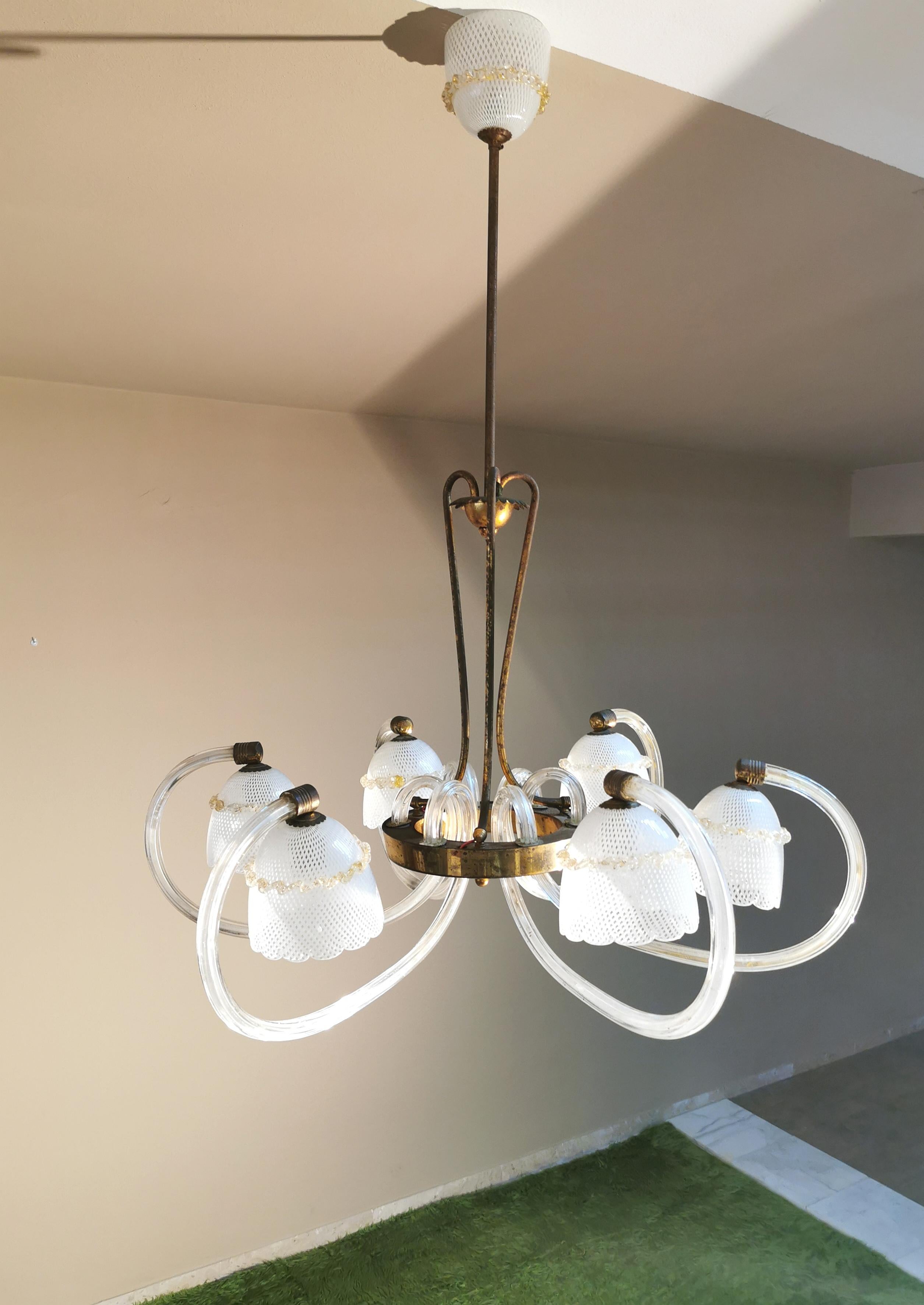 Elegant and refined 6-light chandelier designed by the famous Venetian company Barovier & Toso between the 1930s and 1940s. The chandelier has 6 arms with curved glass housing and Reticello Murano glass diffuser with golden scalloped cord, supported