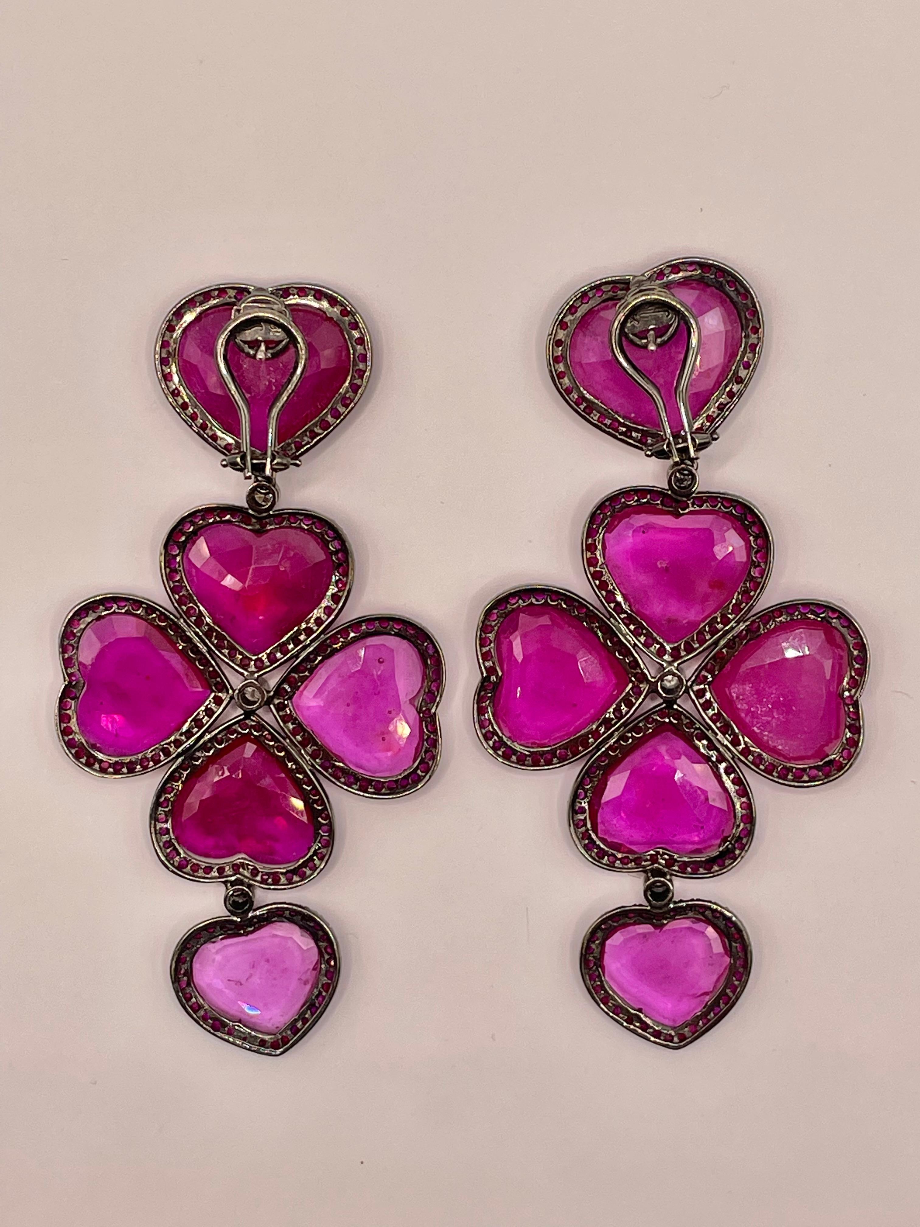 One of a kind ruby chandelier earrings ,made in 18 k white gold covered with black rhodium .4.85ct of rubies ,0.40ct  white diamonds, about 20 ct of  ruby slices in unique heart shape.
Sophisticated  Red Carpet piece  of jewelry !