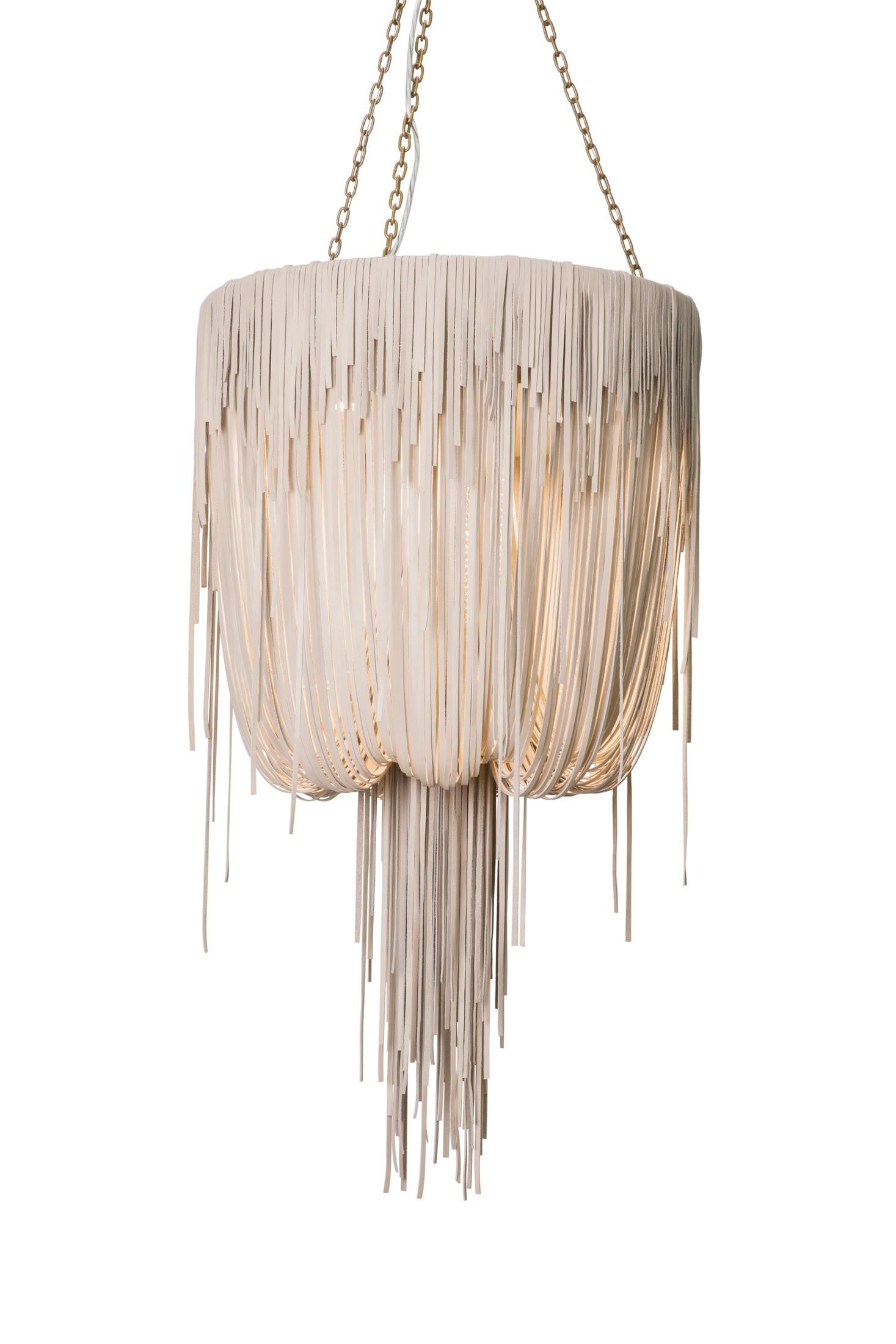 Each chandelier is hand-made with varying lengths of stripped leather, creating layers of movement and texture. The ambient light from within the fixture emerges into the room in a soft glow. All hard-wired lighting is UL-listed for dry locations.