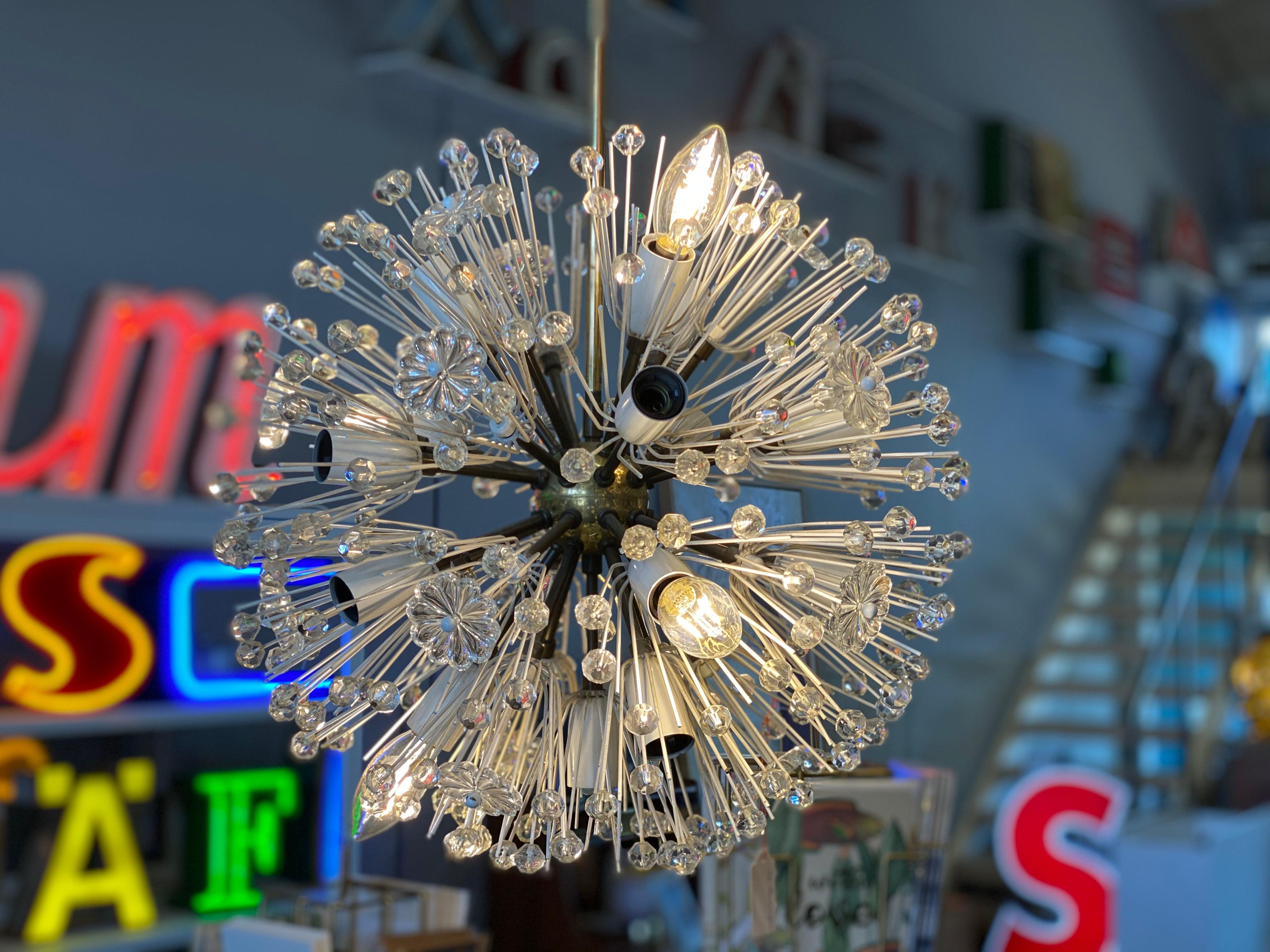 This enchanting chandelier was designed by Emil Stejnar in the 1950s for the Viennese lighting manufacturer Rupert Nikoll. Stejnar's ceiling lamps are characterized by star shapes and delicate glass lacquer. This specimen, the Sputnik lamp, is