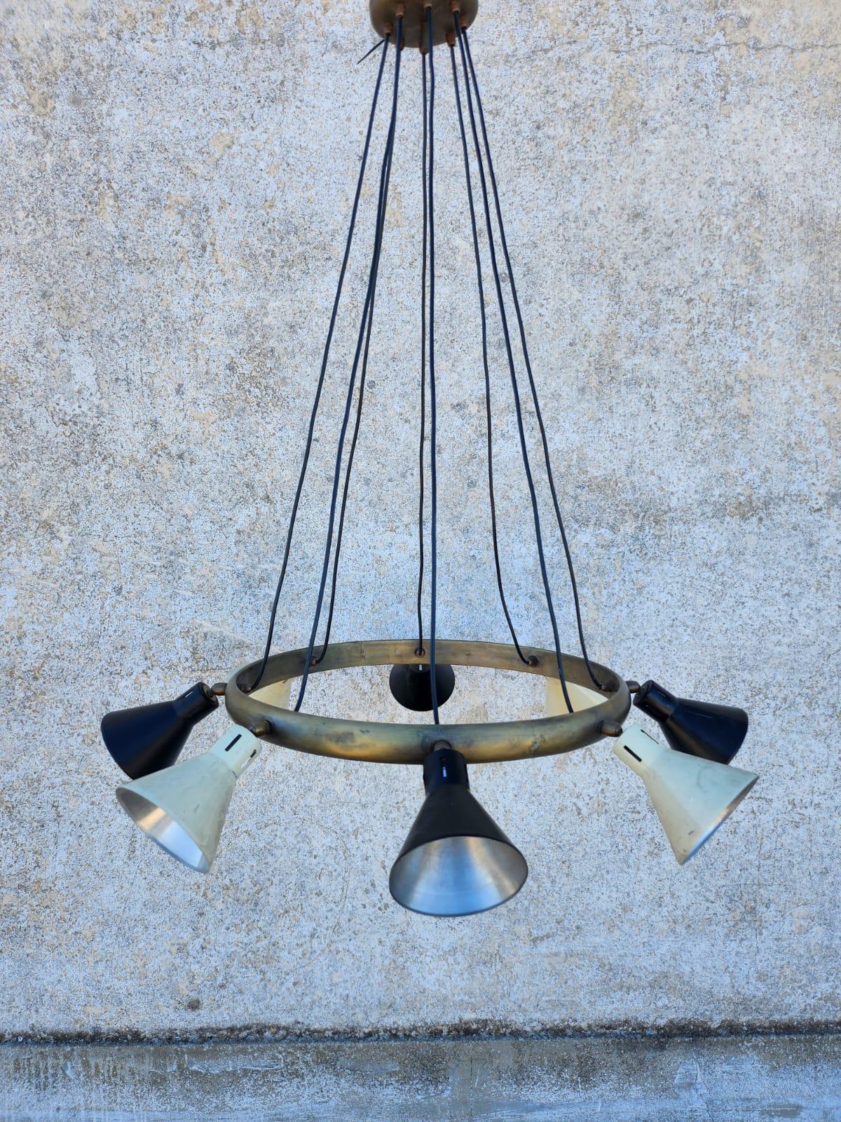 Wonderful hanging chandelier in the style of Stilnovo with 8 patinated brass lampshades. The height from the ceiling is 110 cm but is adjustable by shortening the wires.