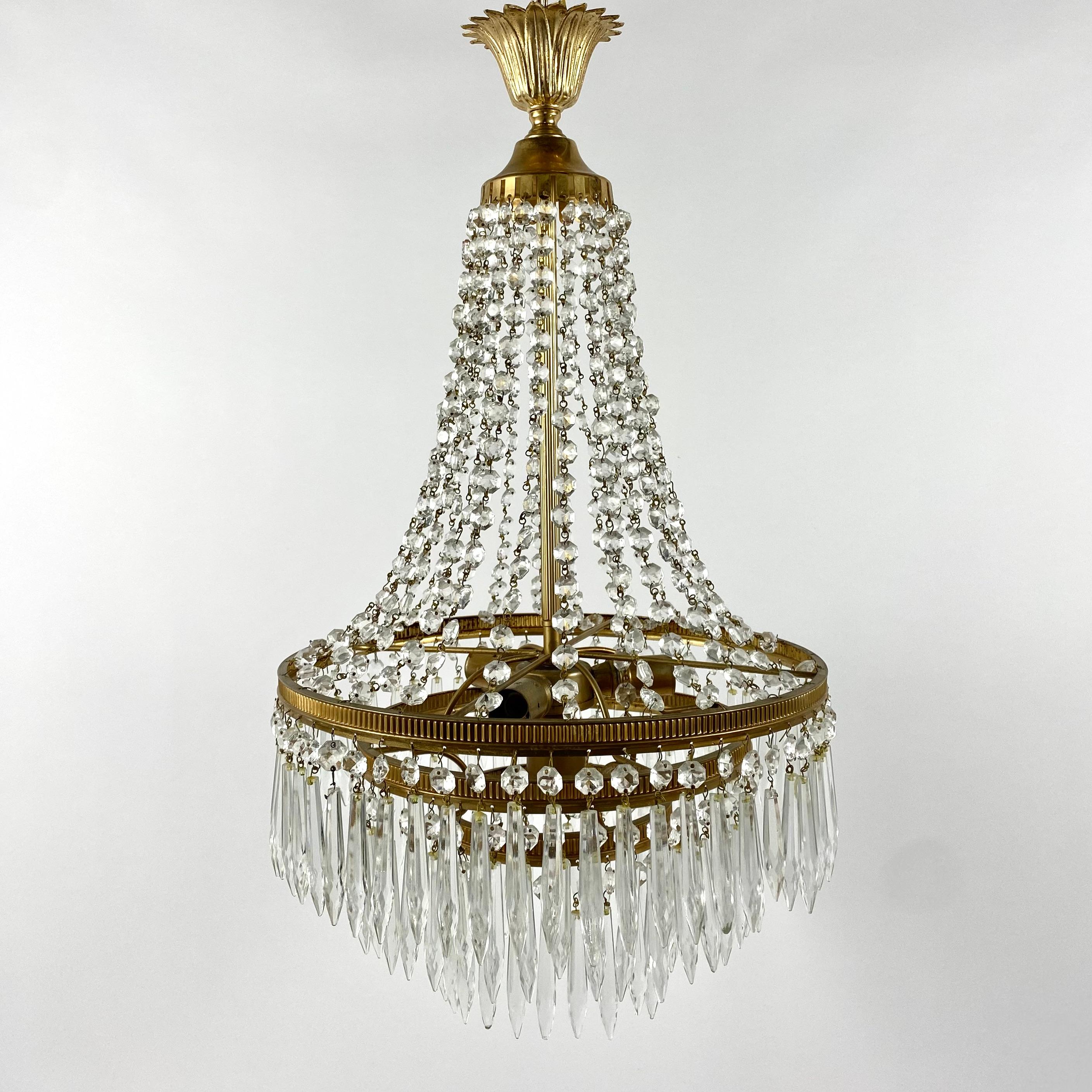 Adorable Crystal Chandelier with Brass Frame, for 3 light points.

Richly Decorated chandelier with decorative elements and pendants made of transparent crystal. 

One of the main advantages of this chandelier is its design. Brass details adorned