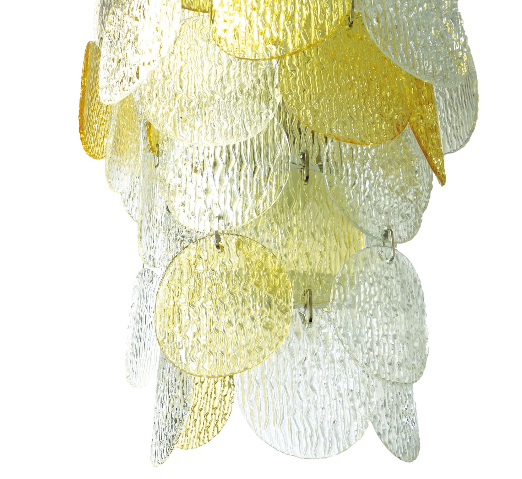 Chandelier Vistosi Torcello Murano glass pendant Italy 1970s yellow white. This object has 26 textured glass discs mounted on aluminum frame including 6 bulb fittings. This chandelier was manufactured in Italy most probably during the early 1970s.
