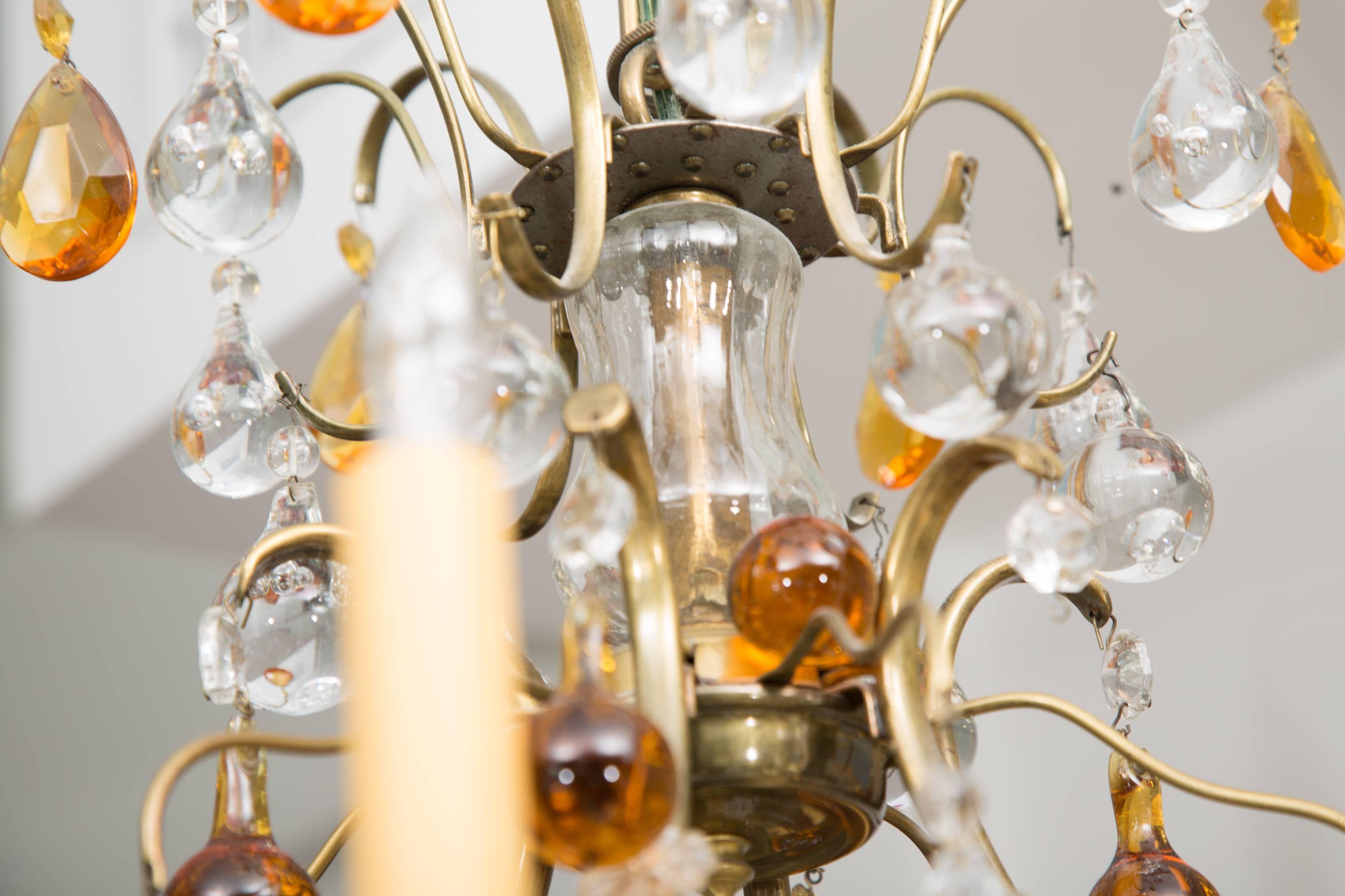 This six-light electrified vintage chandelier is adorned with an overall collection of clear and amber ball-drops.