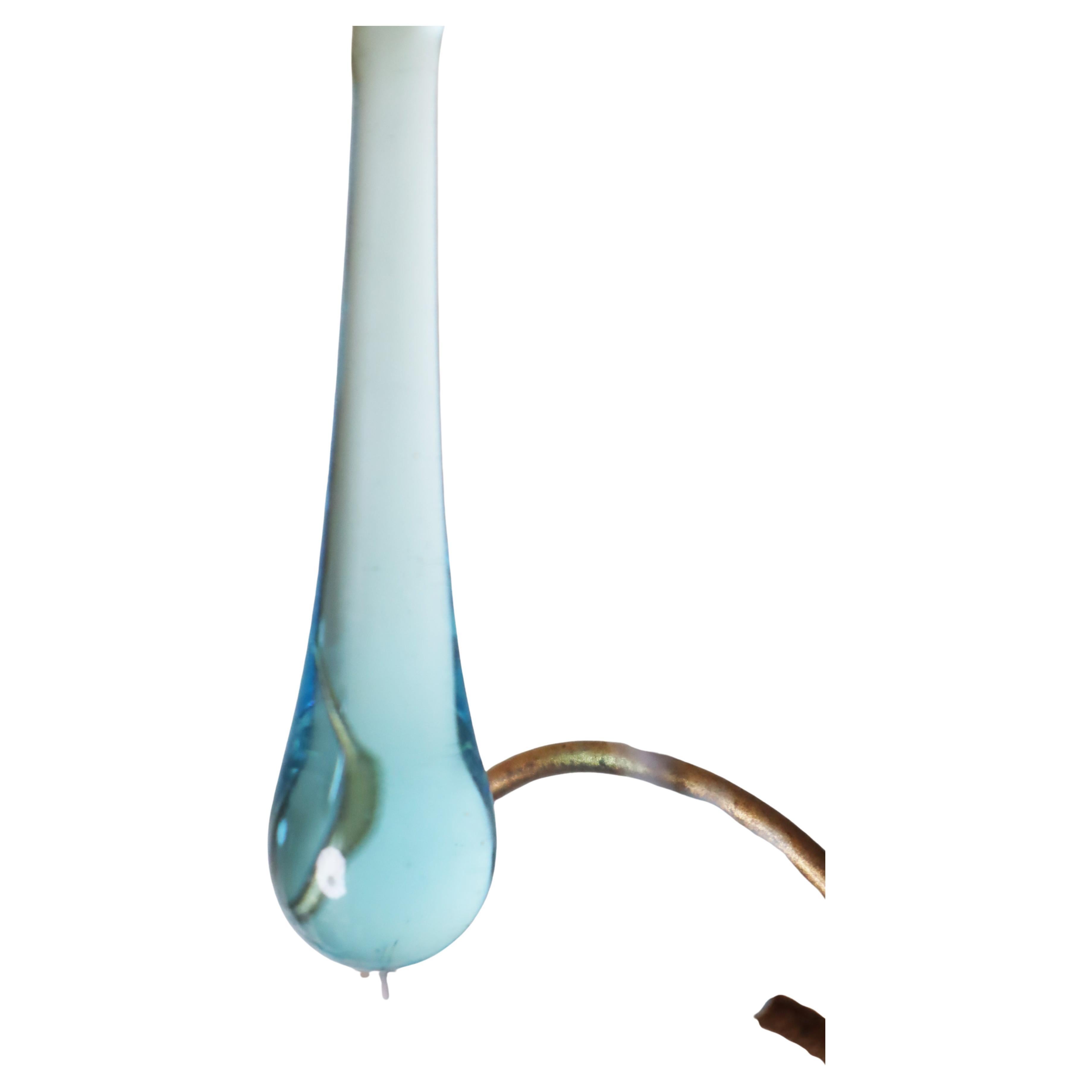 Just imagine yourself in the presence of a Venetian chandelier, adorned with Murano glass drops that reflect the rich blue waters of the Adriatic. Picture the light cups, crafted from the same dreamy Murano glass, reminiscent of the cerulean sky of