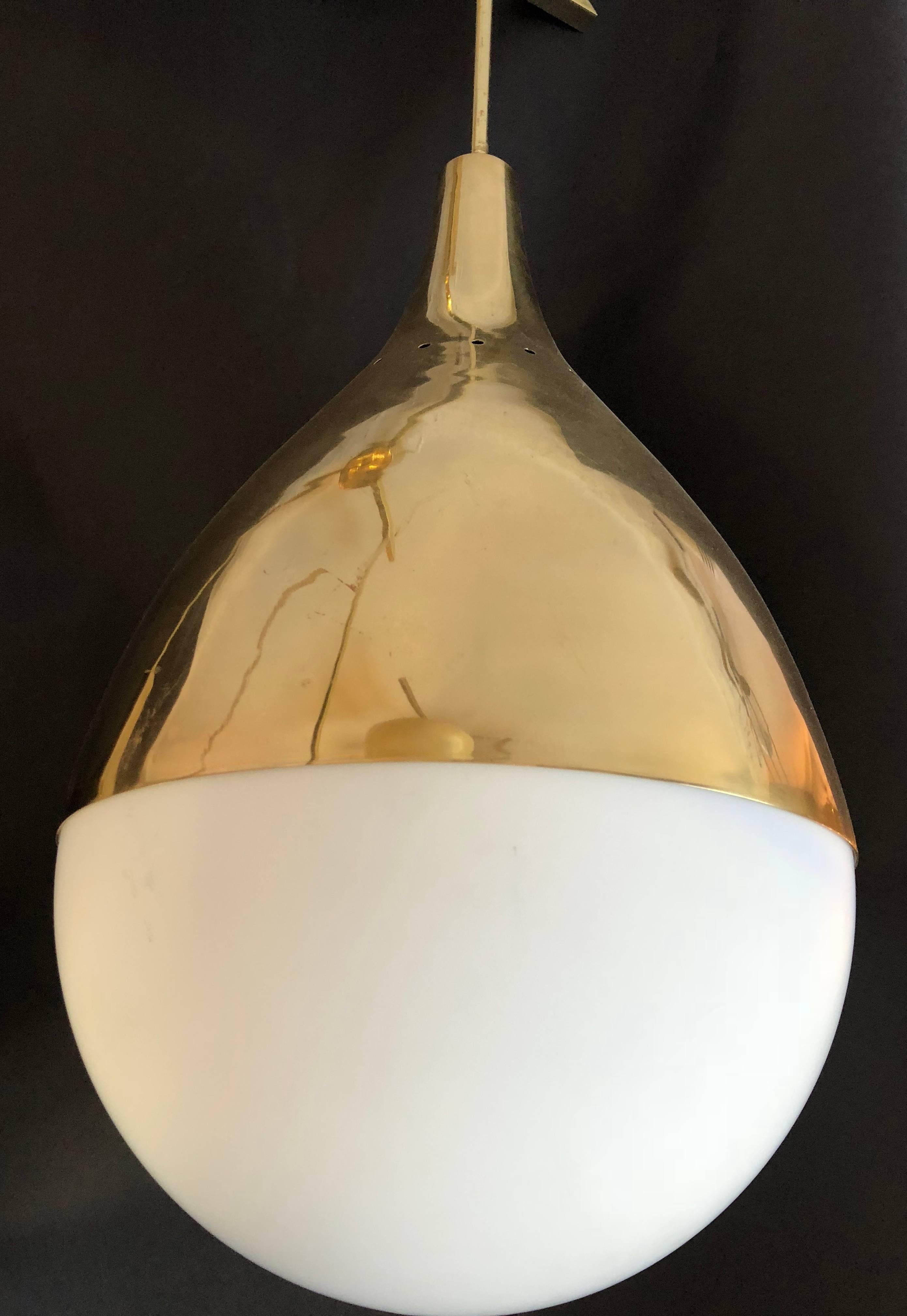 In the style of Stilnovo, Chandelier with three-light,
Golden brass and opaline glass,
circa 2000, Italy.

Measures: Height 112 cm, diameter 70 cm.
