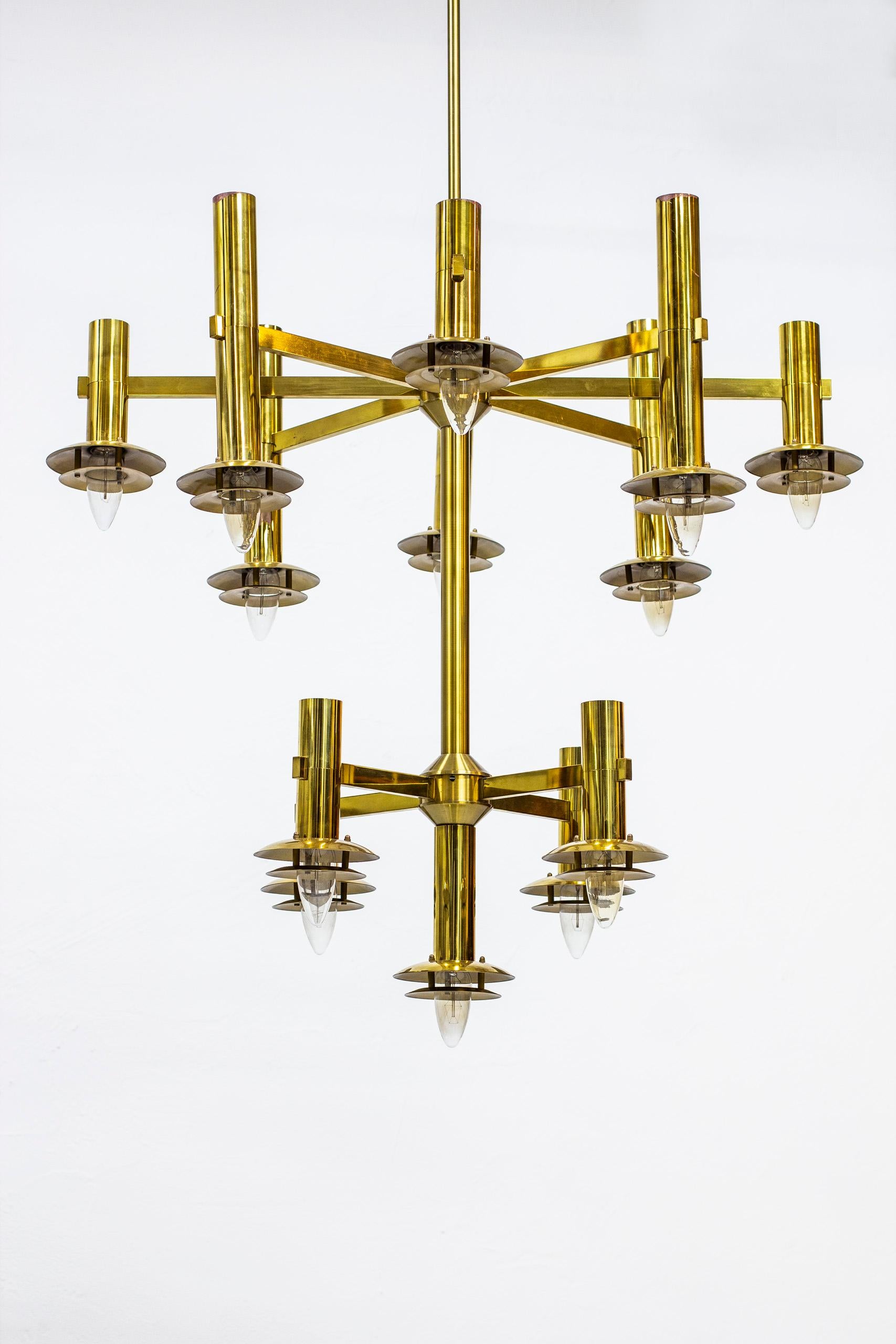 Large chandeliers designed in Sweden by Holger Johansson. Produced by Westal in the 1970s. Made from polished brass consisting of twelve arms and thirteen light sources intended originally for pointy bulbs as pictured. Very good vintage condition