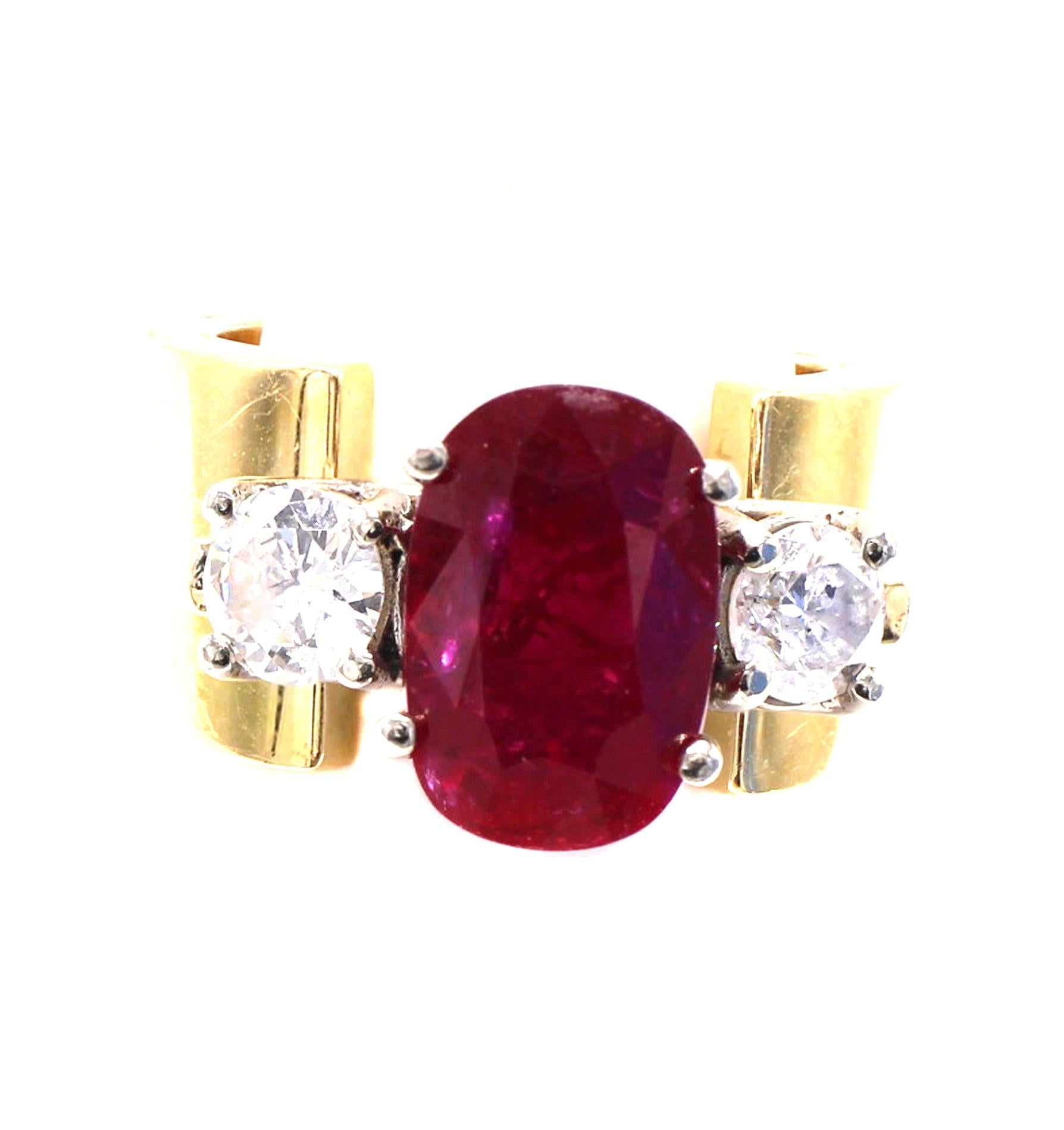 Designed and created by one of the most renown fashion houses in the world, this unique ring is a pure statement on the finger. The wide 18 karat yellow gold band is crowned by an oval pigeon blood red ruby weighing 4.08 carats and accompanied by a
