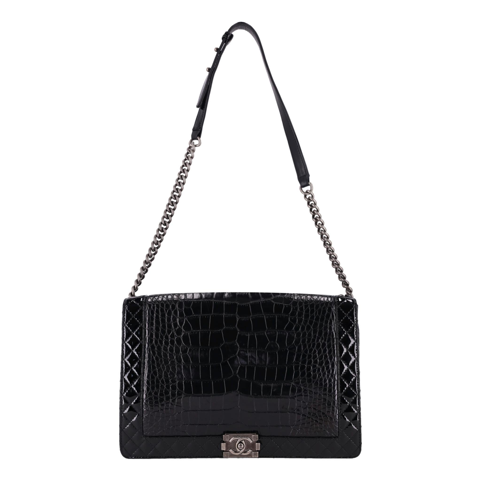 Rare Item - Chanel X/L Reverso Boy Bag In Alligator Skin & Patent Leather 

Black shoulder bag crafted from exotic skin edged with diamond stitched patent leather.

Designed with front flap and iconic 'CC' Boy push-lock closure leading to leather