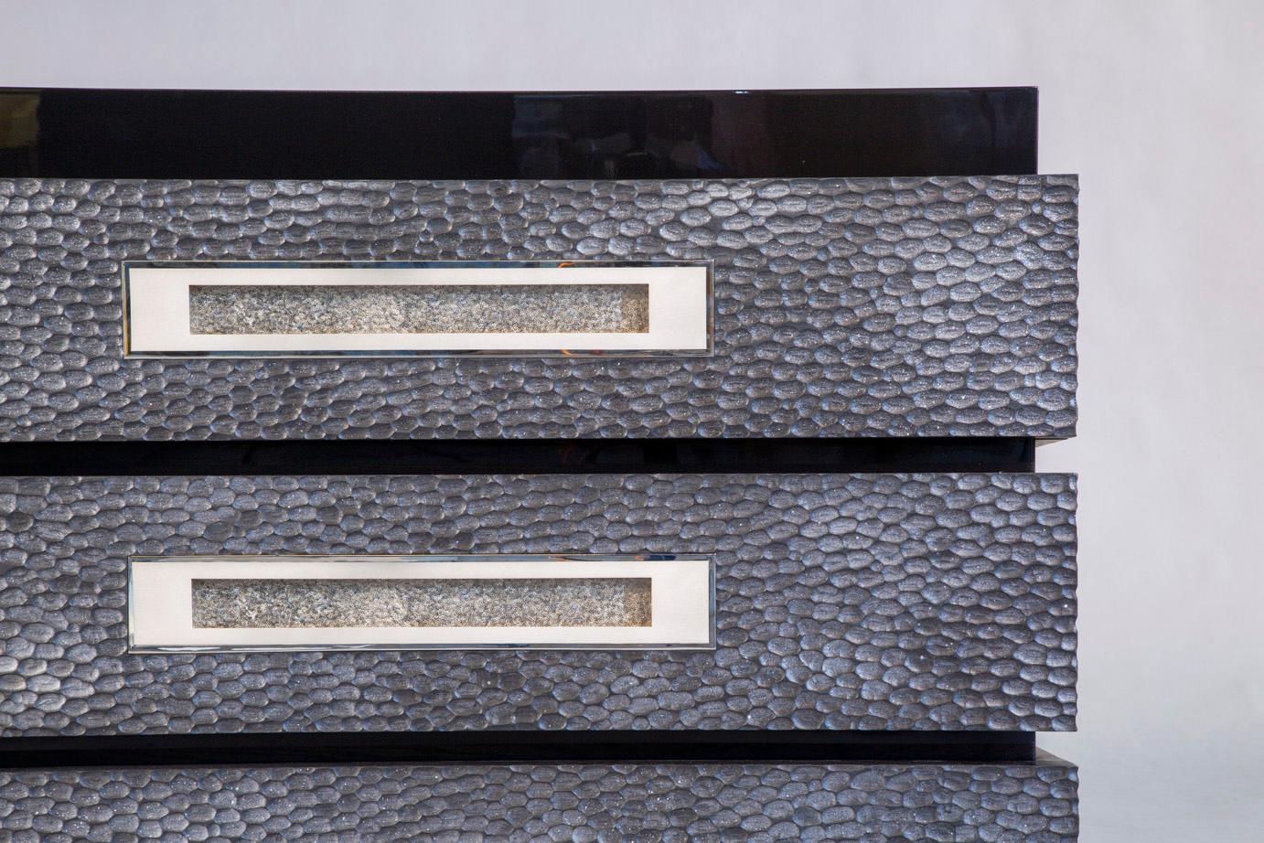 Black piano lacquered main body, with three “bands” of carved silver oak drawers featuring silvered bronze handles. The insides of the drawers are lined with felt. 
