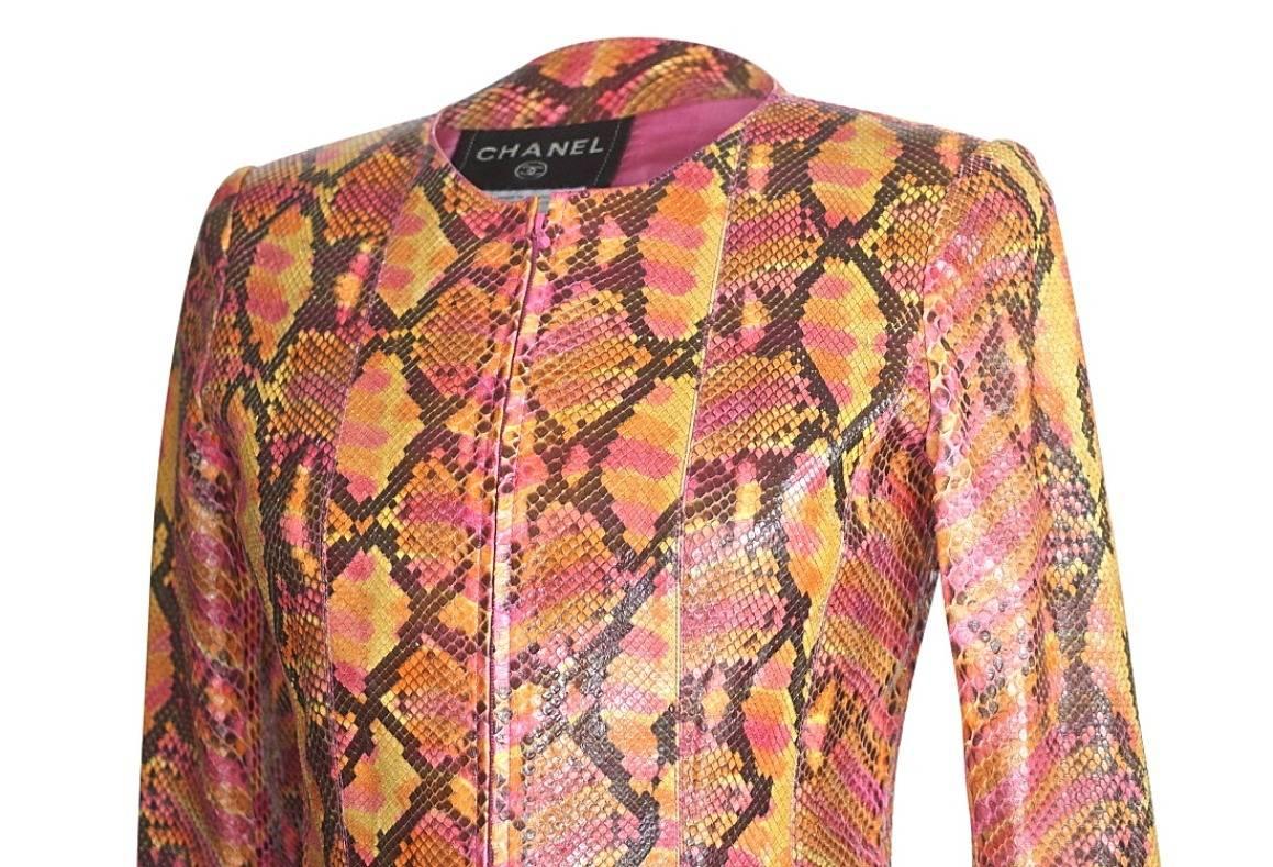 Guaranteed authentic Chanel 00T Limited Edition python jacket in vibrant shades of rose, orange, mustard and brown.
Jewel neckline with zip front and logo embossed pull.
Round metal embossed plaque.
Sleeves are vented.
Fabric is python.
Fully lined