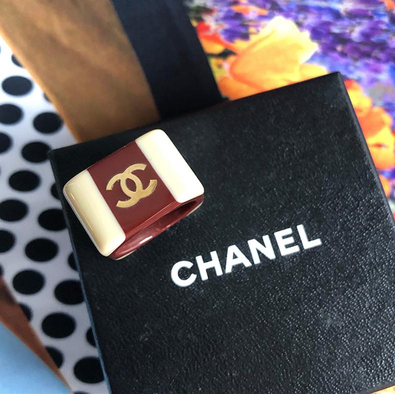Chanel 2001 fall Brown and Beige Two-Tone CC Acrylic Statement Ring.  Square profile ring with gold metal CC logo and color-block design in brown and beige.  Ring size USA 6.  Measures 0.5” tall. Excellent pre-owned condition.  Includes box.
