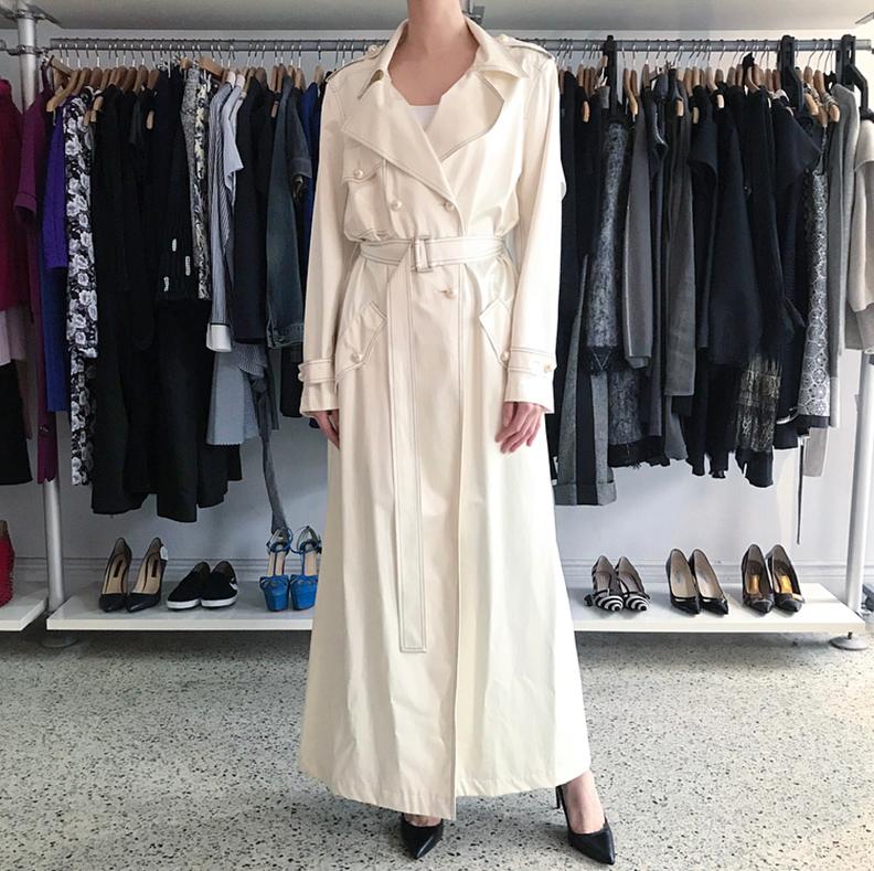 Chanel 01P Ivory Opera Length Day / Night Coat.  Light-weight bonded silk trench style coat with black topstitch design.  Pearl logo buttons, epaulets, and sash belt.  Marked size FR40 (USA 8). Our model is 5’10” without heels. Garment measures 42”
