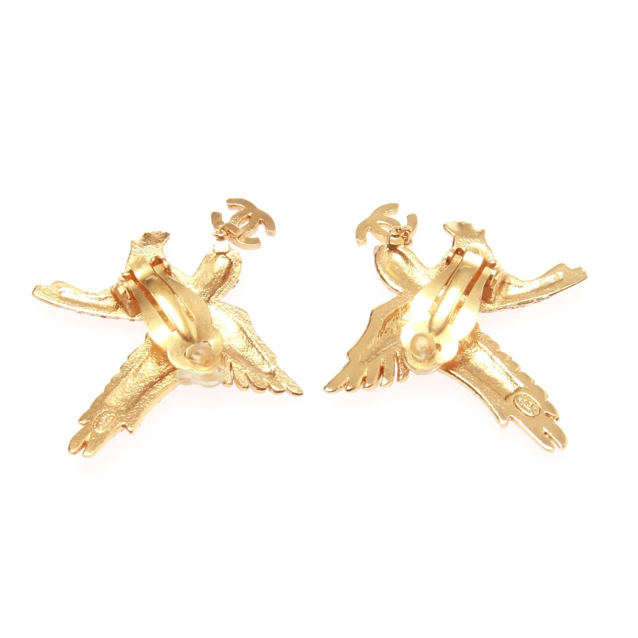 Chanel clip-on earrings featuring sparkling Swarovski crystals with a gold tone metal. Each eagle has a CC 