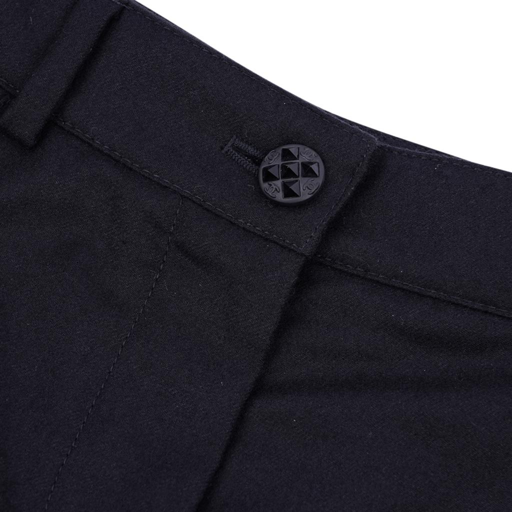 Guaranteed authentic Chanel 04A timeless black wool and cashmere pant.
Beautiful single black CC embossed button with black faceted crystals.
Each leg has a subtle stitched panel for a tuxedo effect.
Flat front with 2 front pockets and 2 rear slot
