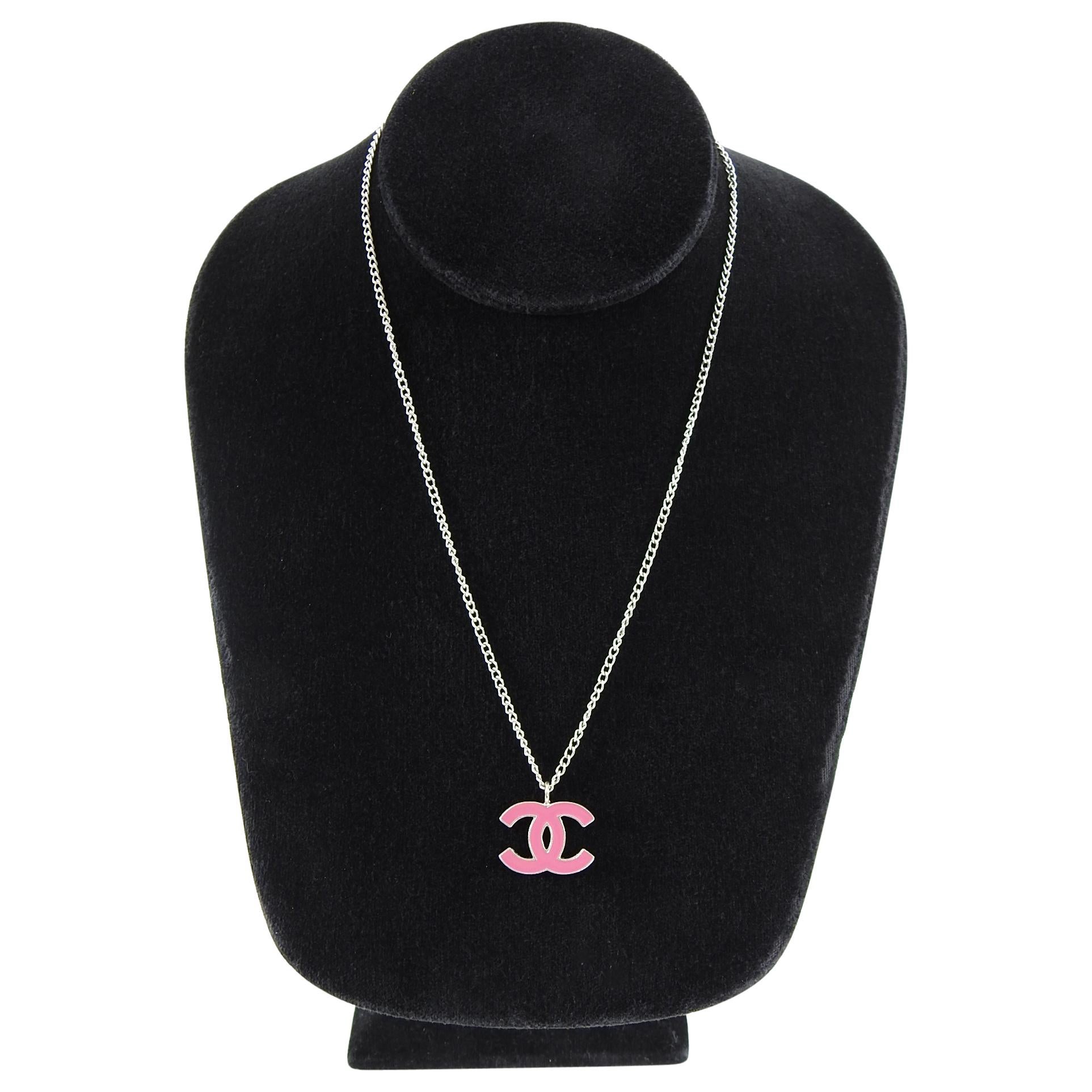 Chanel 2004 Spring Silver and Pink Enamel CC Pendant Necklace.  Classic CC logo pendant on a silvertone thin chain.  Excellent pre-owned condition. Necklace is 16” long and pendant is 0.75” wide. 
