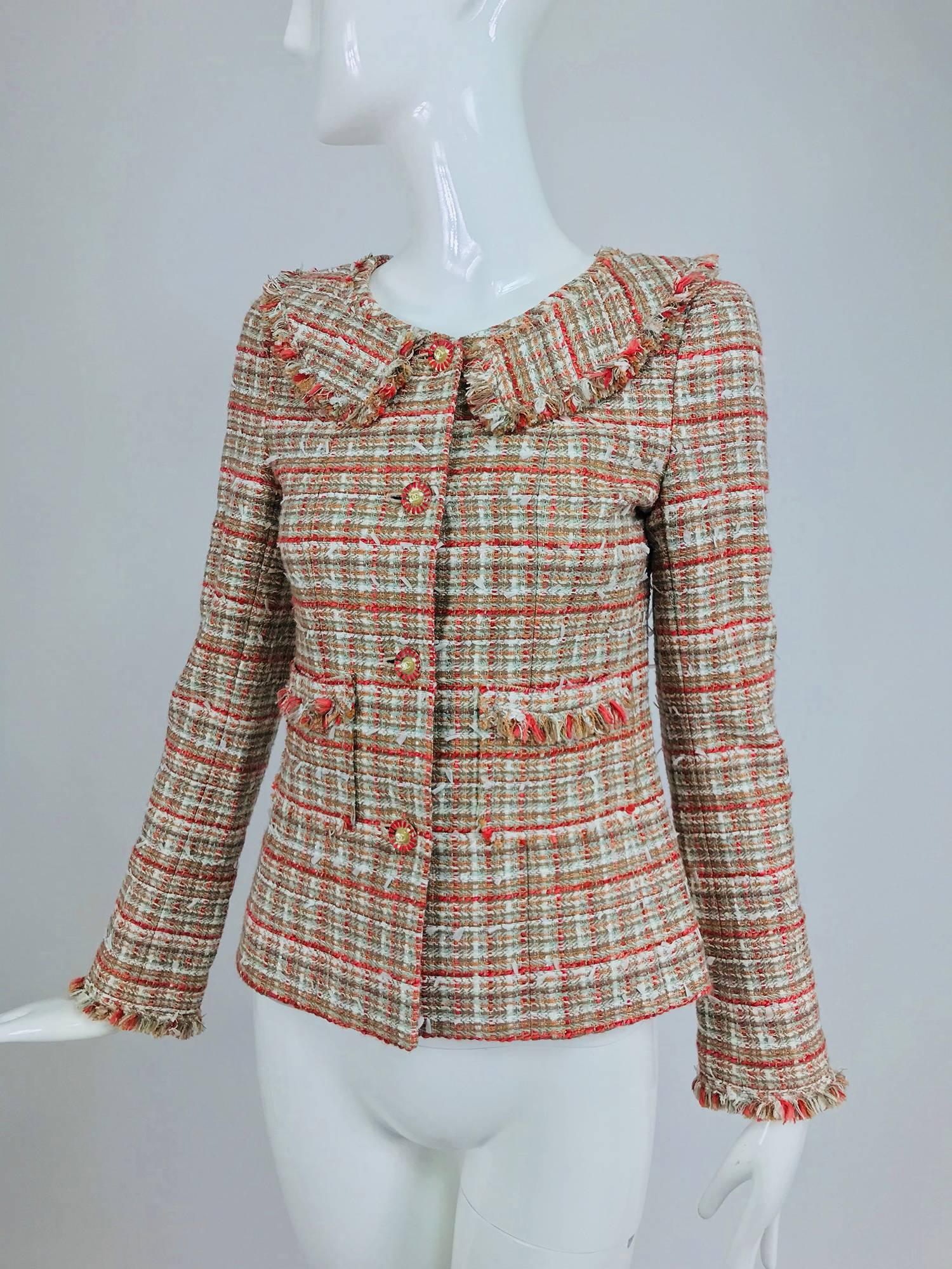 Chanel 04P tweed fringe four pocket jacket with yoke collar...Beautiful jacket in soft colours, coral, moss green and cream...Fringe trim pockets...Logo buttons...Looks barely, if ever worn...Marked size 36
In excellent wearable condition... All our