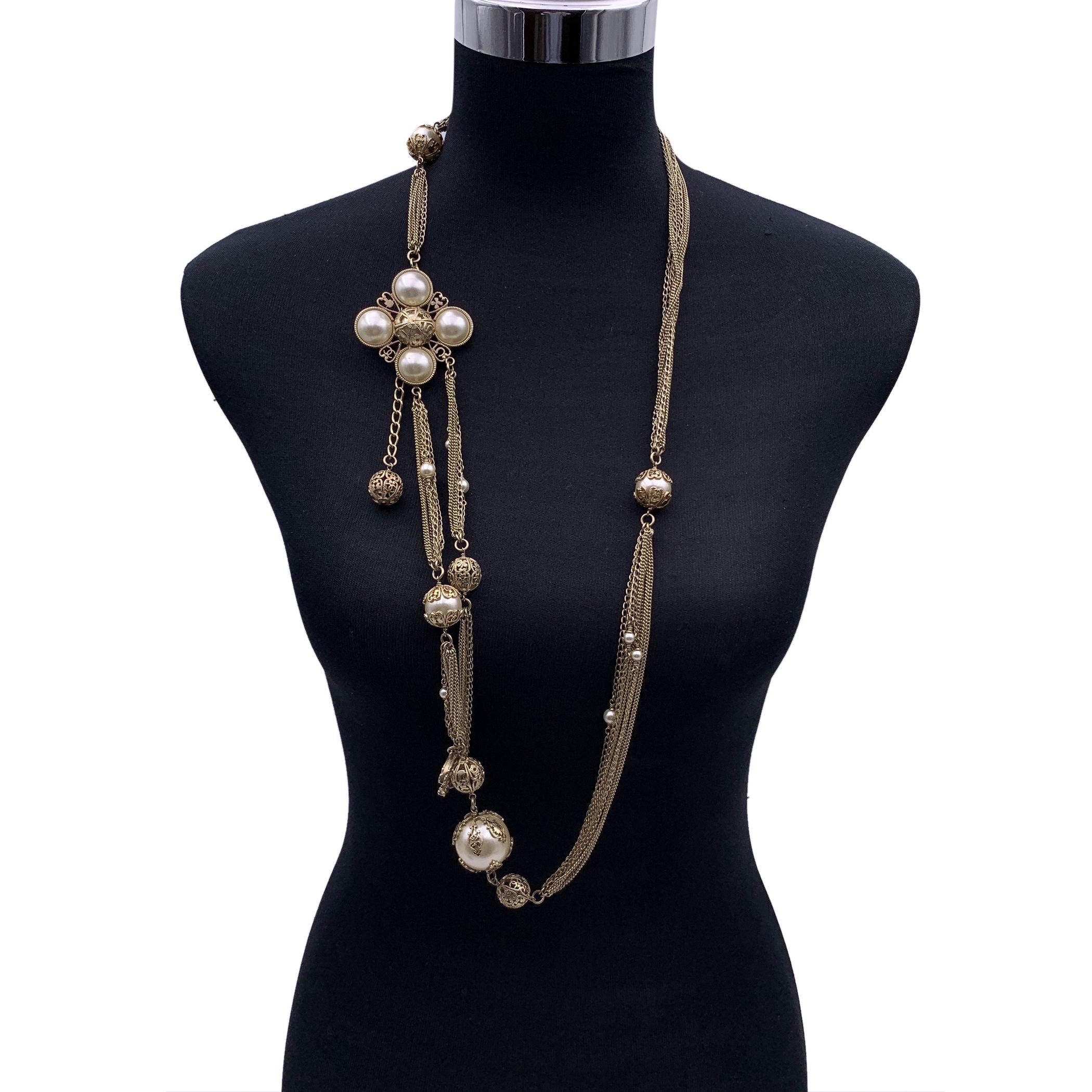 Discover the epitome of versatility and elegance with this stunning Chanel Gold Metal Faux Pearl Necklace or Belt, a beautiful piece from the 2006 collection. Crafted with a multi-chain design, this accessory exudes a timeless sophistication that