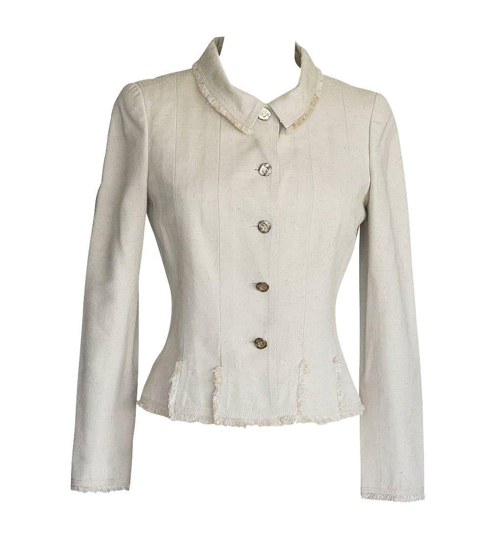Guaranteed authentic Chanel 06P raw silk skirt suit.
Fabulous textured Chanel skirt suit in a stone shade.
Jacket is single breast with 5 distressed logo embossed buttons.
Signature fringe around collar, cuffs and bottom of jacket. 
2 working