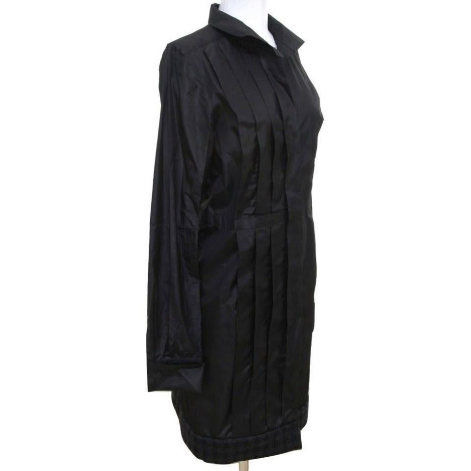 GUARANTEED AUTHENTIC CHANEL 08A STUNNING LONG BLACK SILK COAT
EDGED WITH CASHMERE TRIM AT HEM
Pictures lightened to show detail

• Design:
  - Stunnig jet black coat that may be worn as a dress also in silk taffeta.
  - Front covered button closure