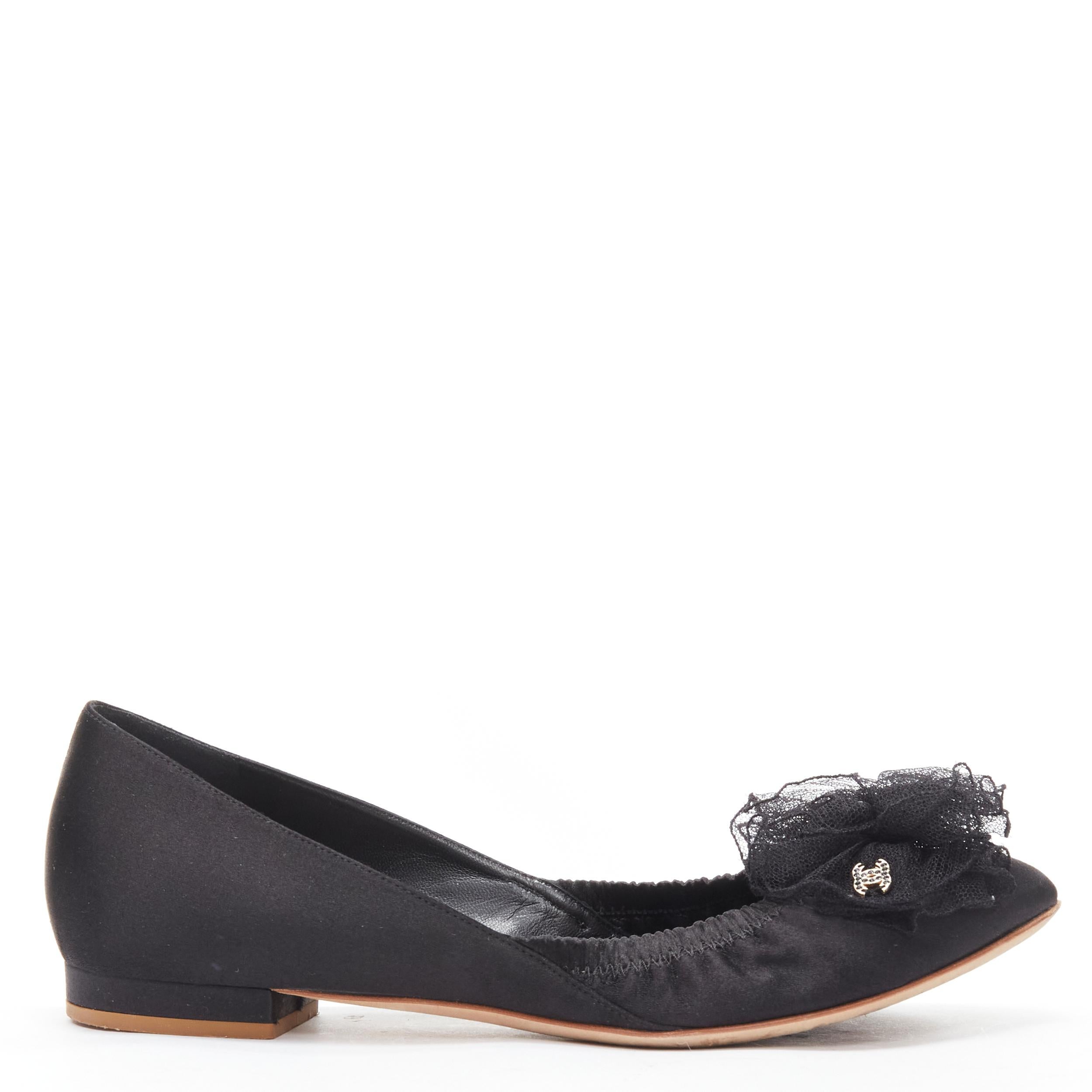 CHANEL 08C G G25751 black lace Camellia floral gold CC ballerina flats EU37.5 
Reference: MELK/A00214 
Brand: Chanel 
Material: Satin 
Color: Black 
Pattern: Solid 
Closure: Lace Up 
Extra Detail: Cc gold-tone CC detail. 
Made in: Italy 

CONDITION:
