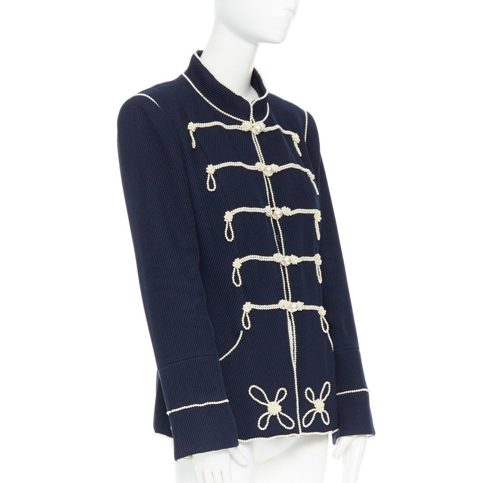 CHANEL 09P navy blue twill trompe loeil white pearl military jacket FR48
Brand: CHANEL
Designer: Karl Lagerfeld
Collection: 09P
Model Name / Style: Military jacket
Material: Other; composition lanel removed. Feels like cotton twill.
Color: Navy and
