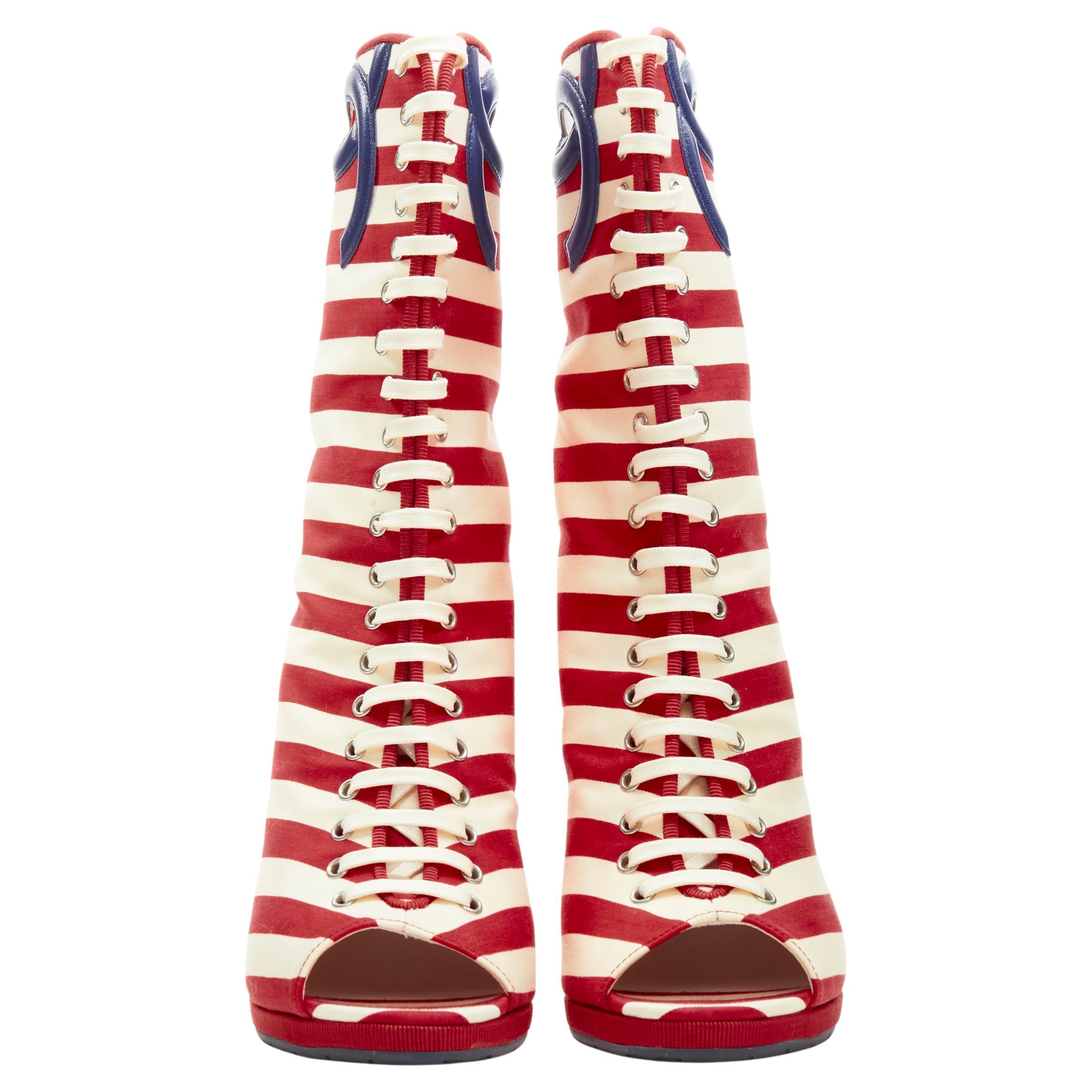 CHANEL 10C red white striped navy CC logo peep toe wedge boot EU36.5
Brand: Chanel
Material: Fabric
Color: Red
Pattern: Striped
Closure: Lace Up
Extra Detail: Leather CC logo cut out. Wedge heel. Laced front. CC logo charm at heel.
Made in: