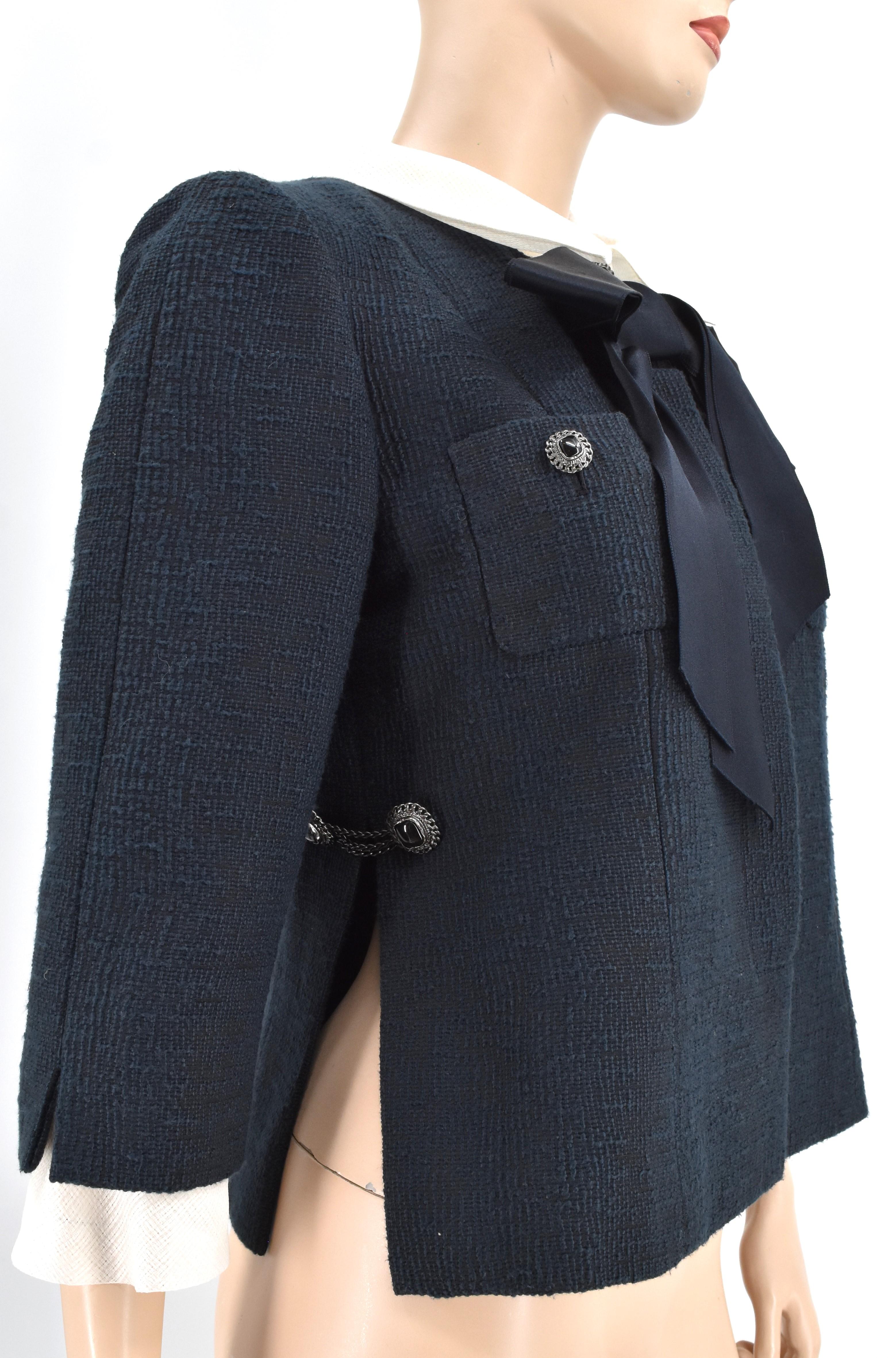 Chanel Runway bow jacket from Spring 2010. It is adorned with detachable collar and sleeve trim, front pockets, and Chanel interlocking CC logo buttons. This is new without tags.