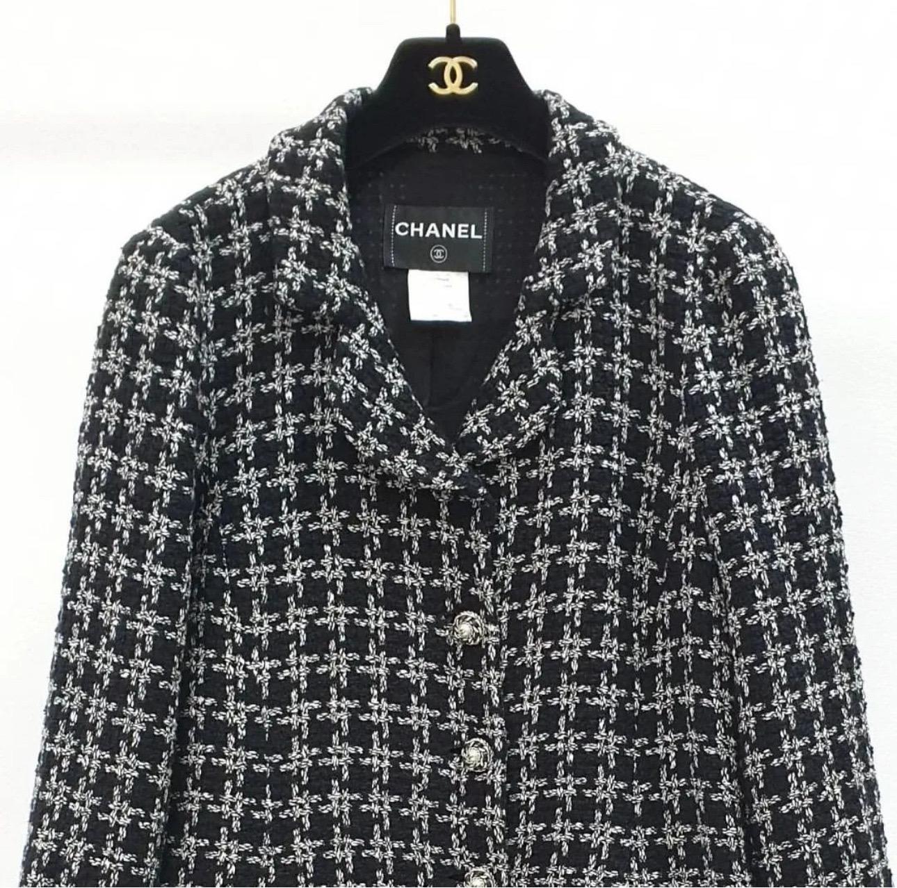 This stunning jacket from Chanel will become a staple in your wardrobe. 

This jacket features a classic blazer silhouette made from gorgeous cotton and silk blend in a chic black with white large check pattern. Ornamental faux pearl and leather