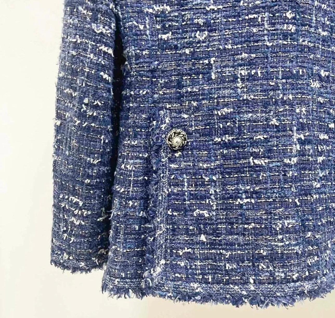 From the Fall 2010 Collection. 
Chanel navy blue, ecru and white  tweed jacket with stunning pearl and chain-link buttons. 
Signature fringe trim throughout, chain link at interior hem. 
Retail price was 6.650€. 
Size mark 40fr. 
Very good