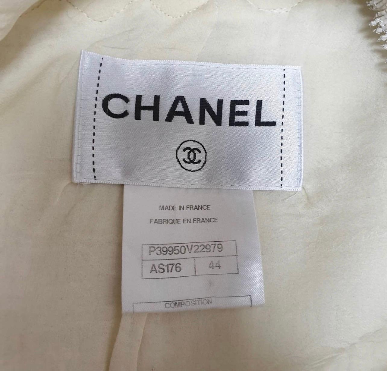 Chanel Most Wanted Ecru Tweed Jacket  and Skirt with Camellia crochet trim, beaded embellishments throughout.
Jacket has crew neck, four patch pockets, and Gripoix Gold CC logo button front closure.

From the 2011C Collection

Sz.44

Condition is