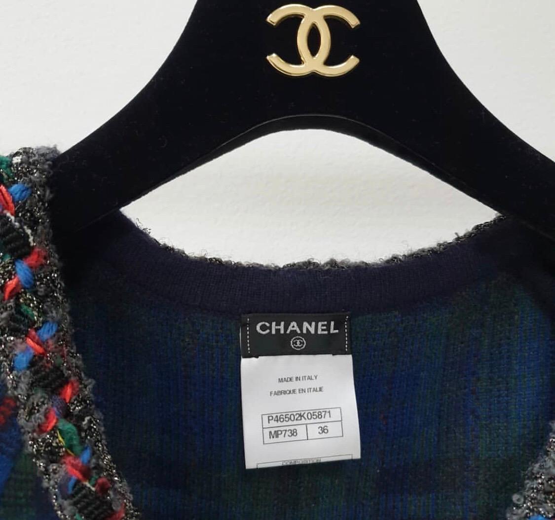 Look from the Pre-Fall 2013 Métiers d'Art Runway.
Multicolor Chanel cashmere jacket with plaid pattern and braided trim throughout, dual patch pockets and hook-and-eye closures featuring Gripoix button accents at front. 
Sz.36
Very good