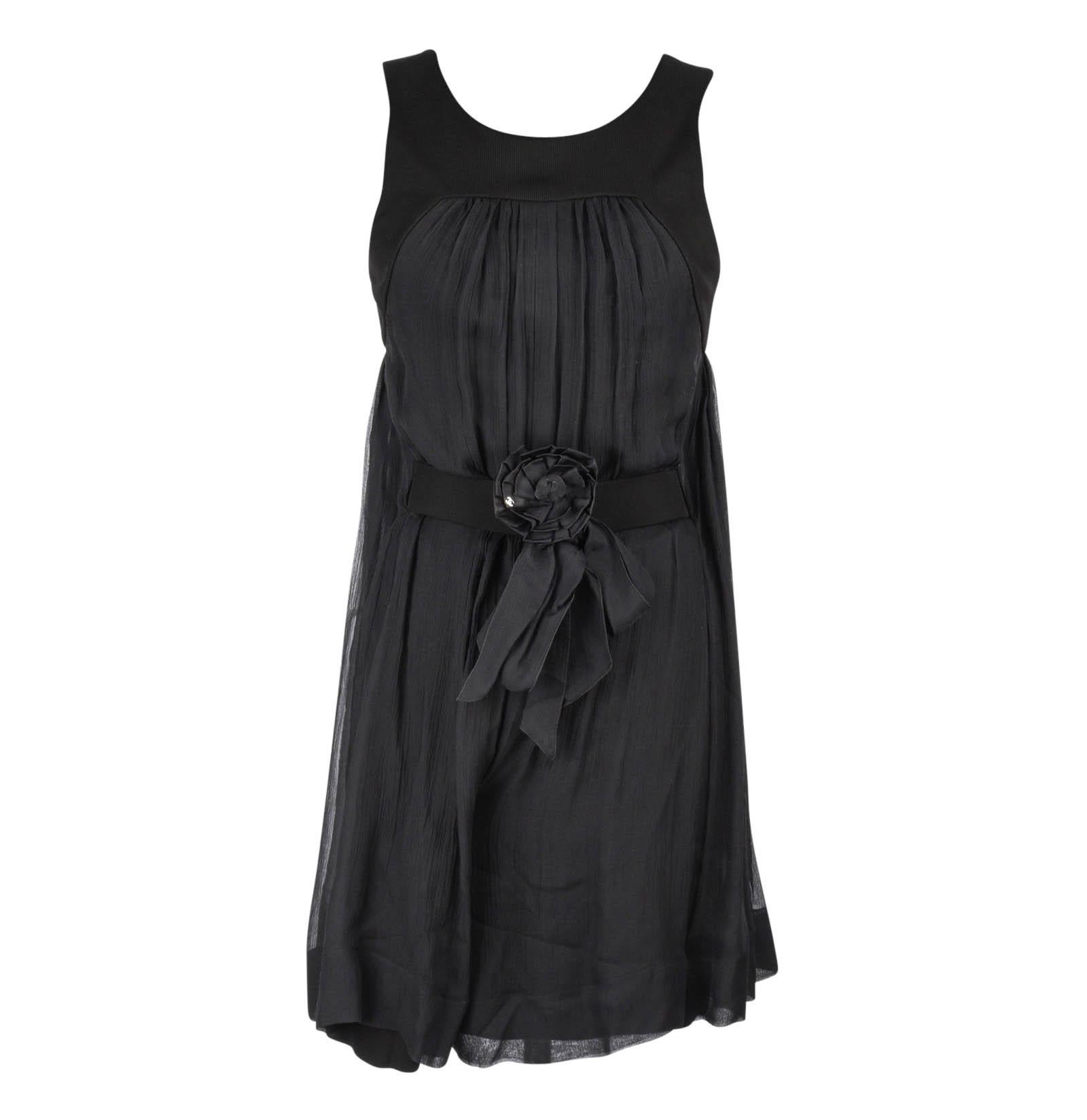 Guaranteed authentic Chanel 13P black dinner / cocktail culotte dress.
Dress is sleeveless and gently gathered at neck and rear.
The attached belt has a signature camellia in black with small silver CC.
Rear neckline is squared off with 2 CC