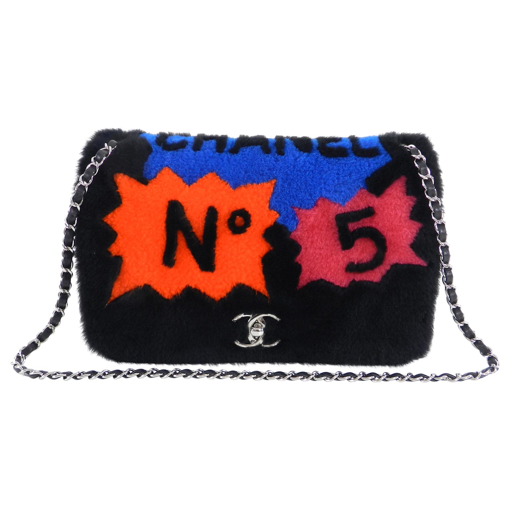 Chanel 14A Patchwork No. 5 Caption Comic Shearling jumbo flap bag in black. Limited edition bag with original retail price of $7450 CAD.  Comic text design in hot pink, orange, yellow, and blue.  Soft shearling exterior with quilted lambskin body. 