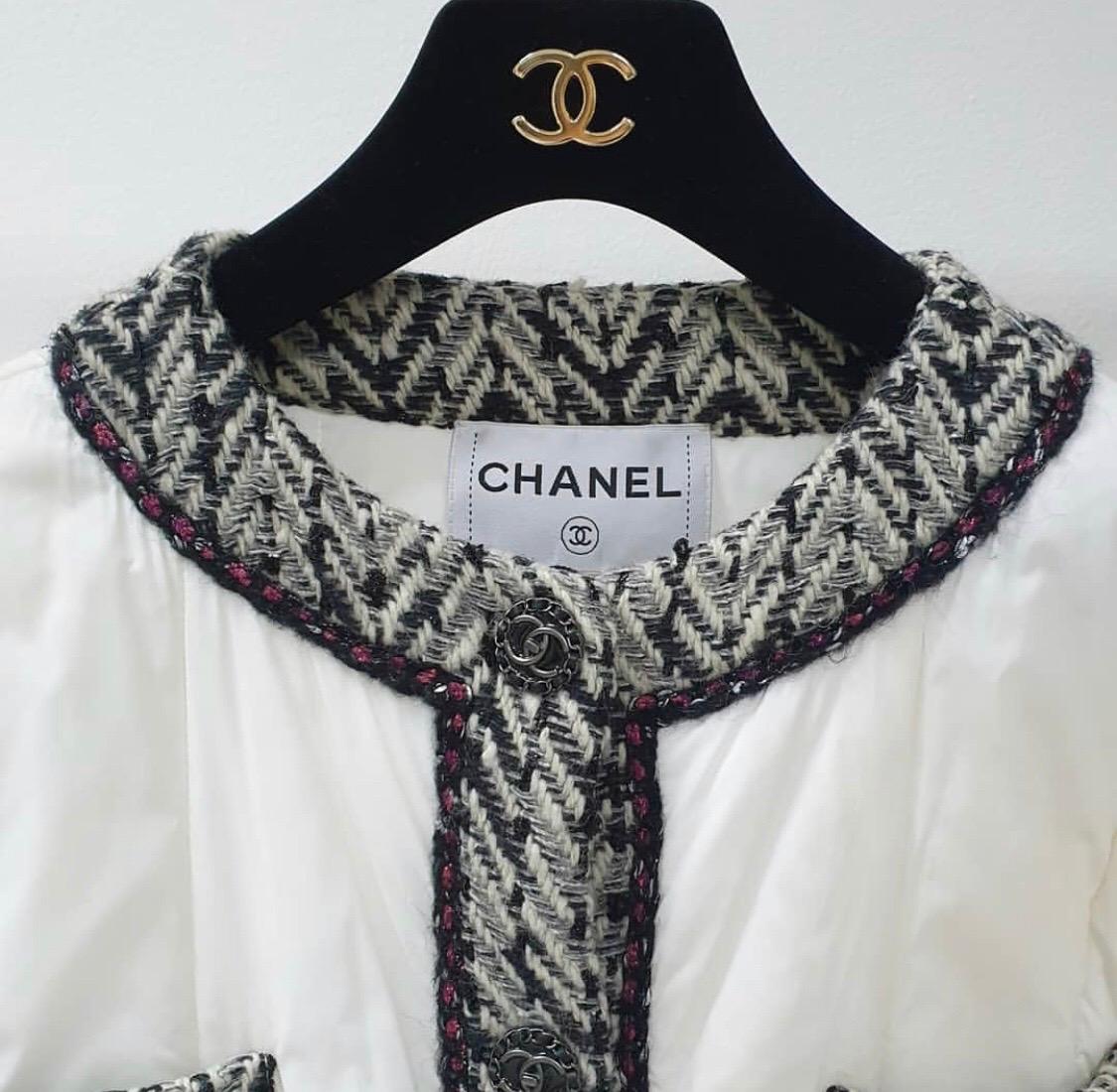 This is an outstanding, extremely rare, and recent runway puffer jacket by Chanel. It is part of the ensembles for looks 66, 67, and 68 from the Autumn 2018 Runway Collection. The jacket is a medium-weight puffer in style and white in color. The