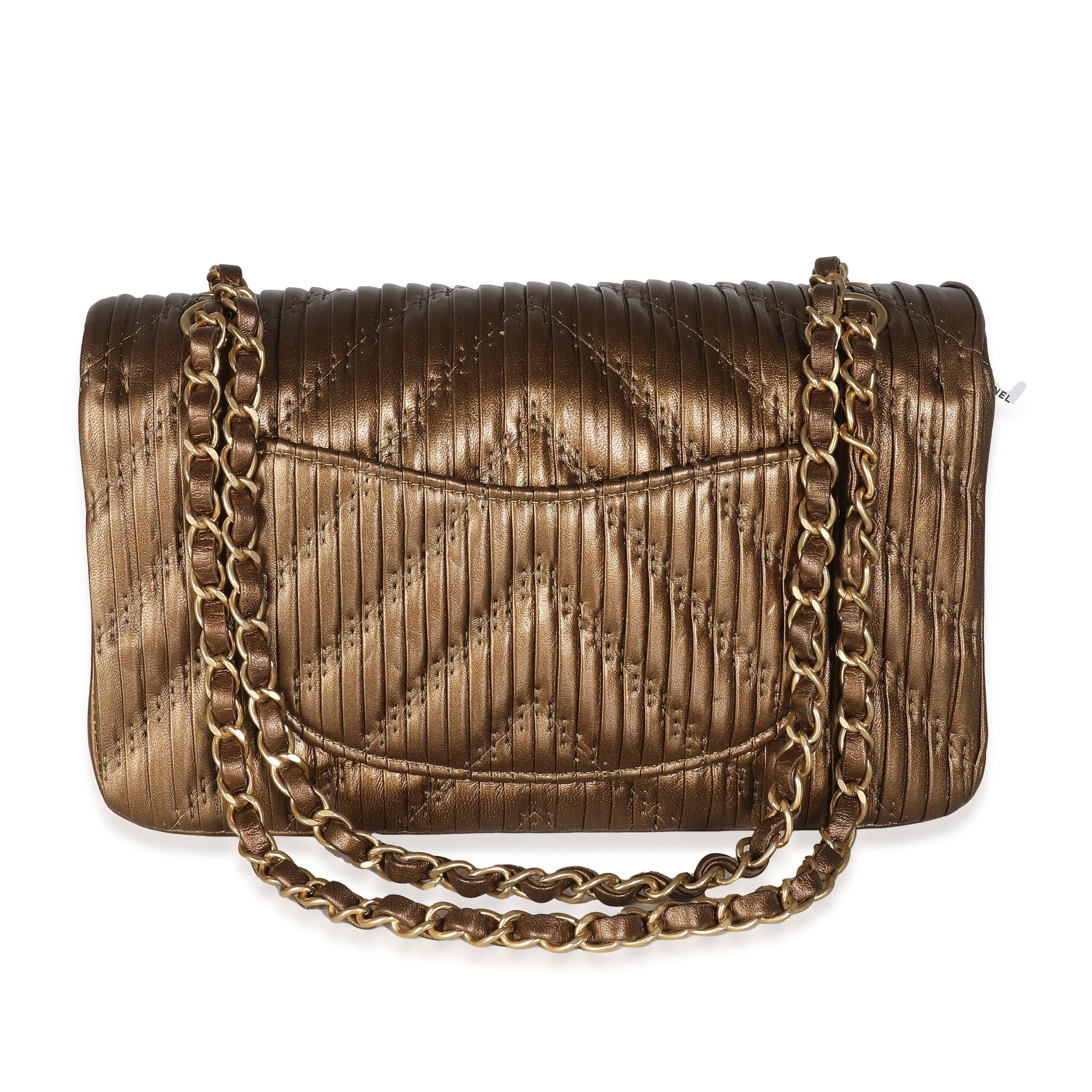 Listing Title: Chanel 18C Bronze Chevron Pleated Calfskin Medium Classic Double Flap Bag
SKU: 140093
Condition: Pre-owned 
Condition Description: A timeless classic that never goes out of style, the flap bag from Chanel dates back to 1955 and has